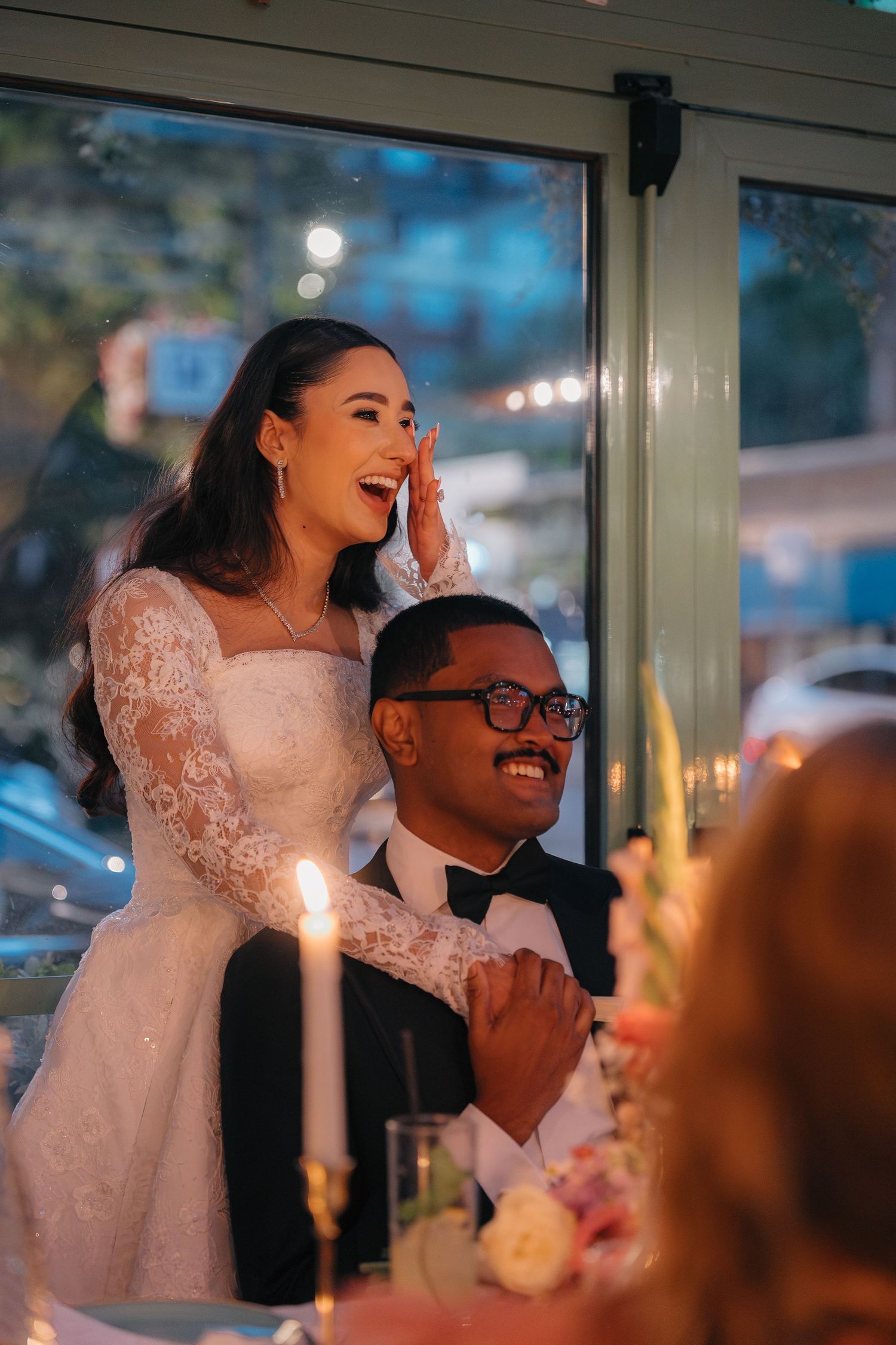 Joyful candid moments captured during the wedding reception dinner.