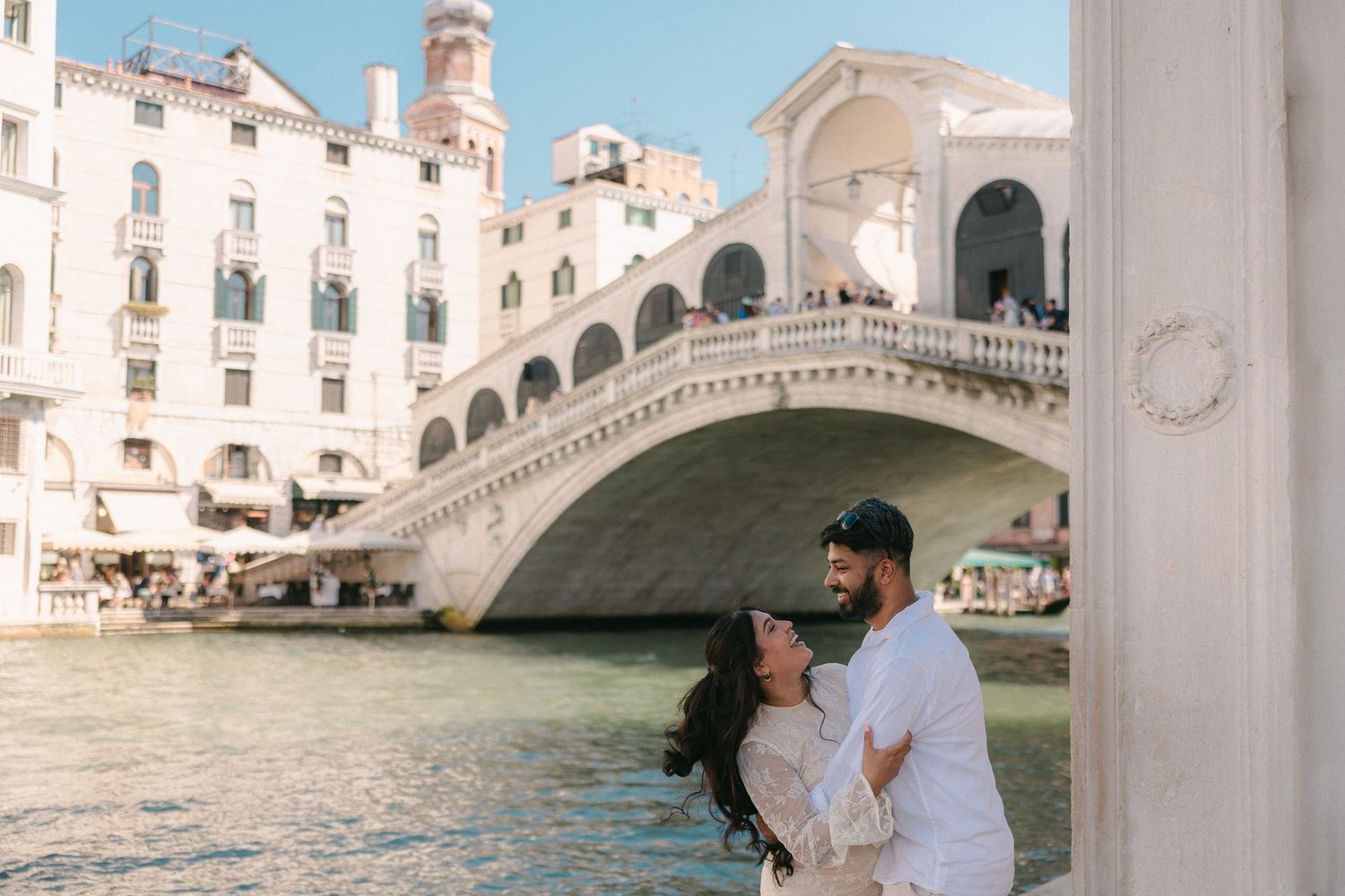 Romantic couple photoshoot against stunning Venetian architecture and canals.