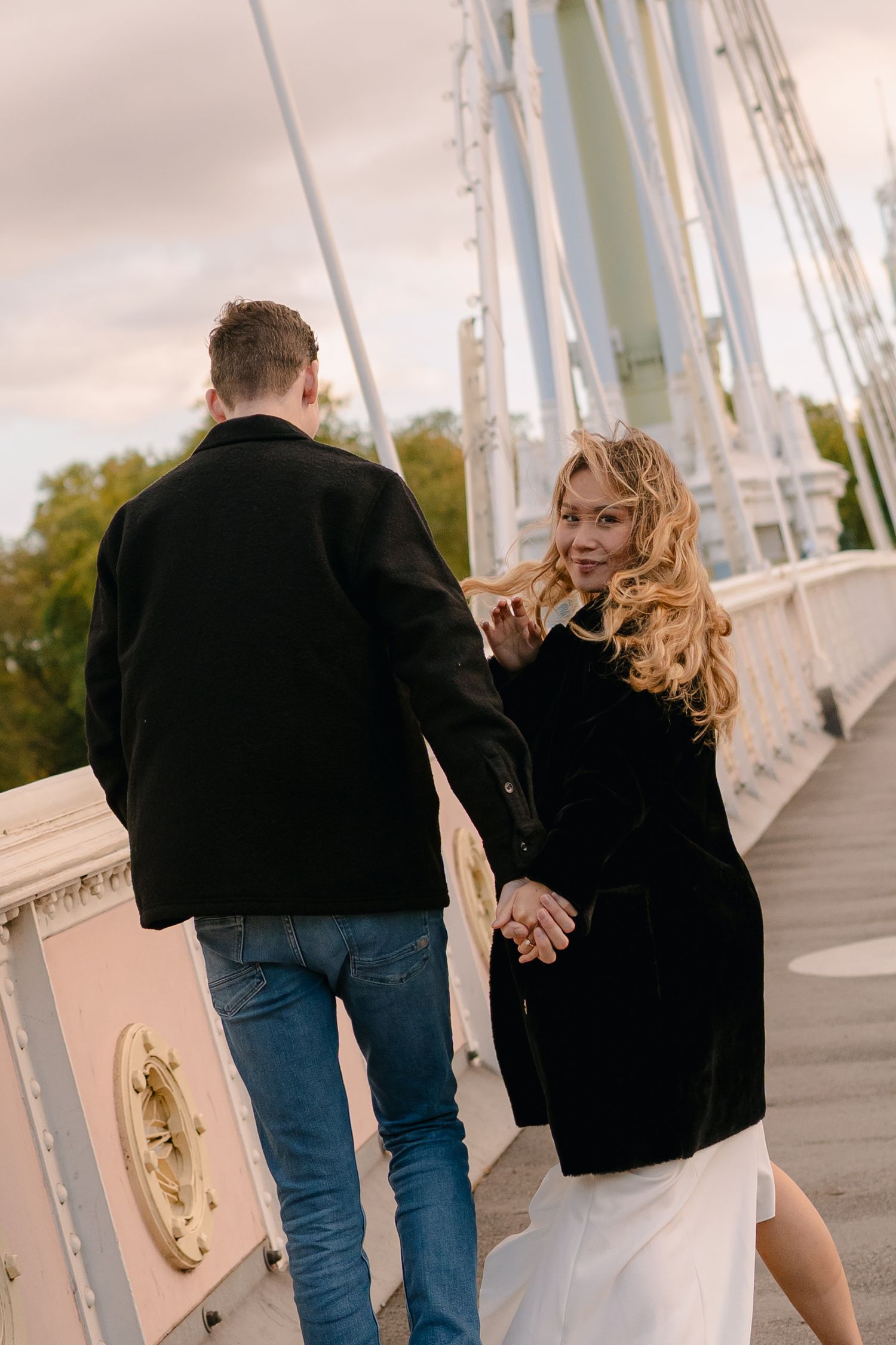 Romantic walk along a white bridge during sunset. Albert Bridge