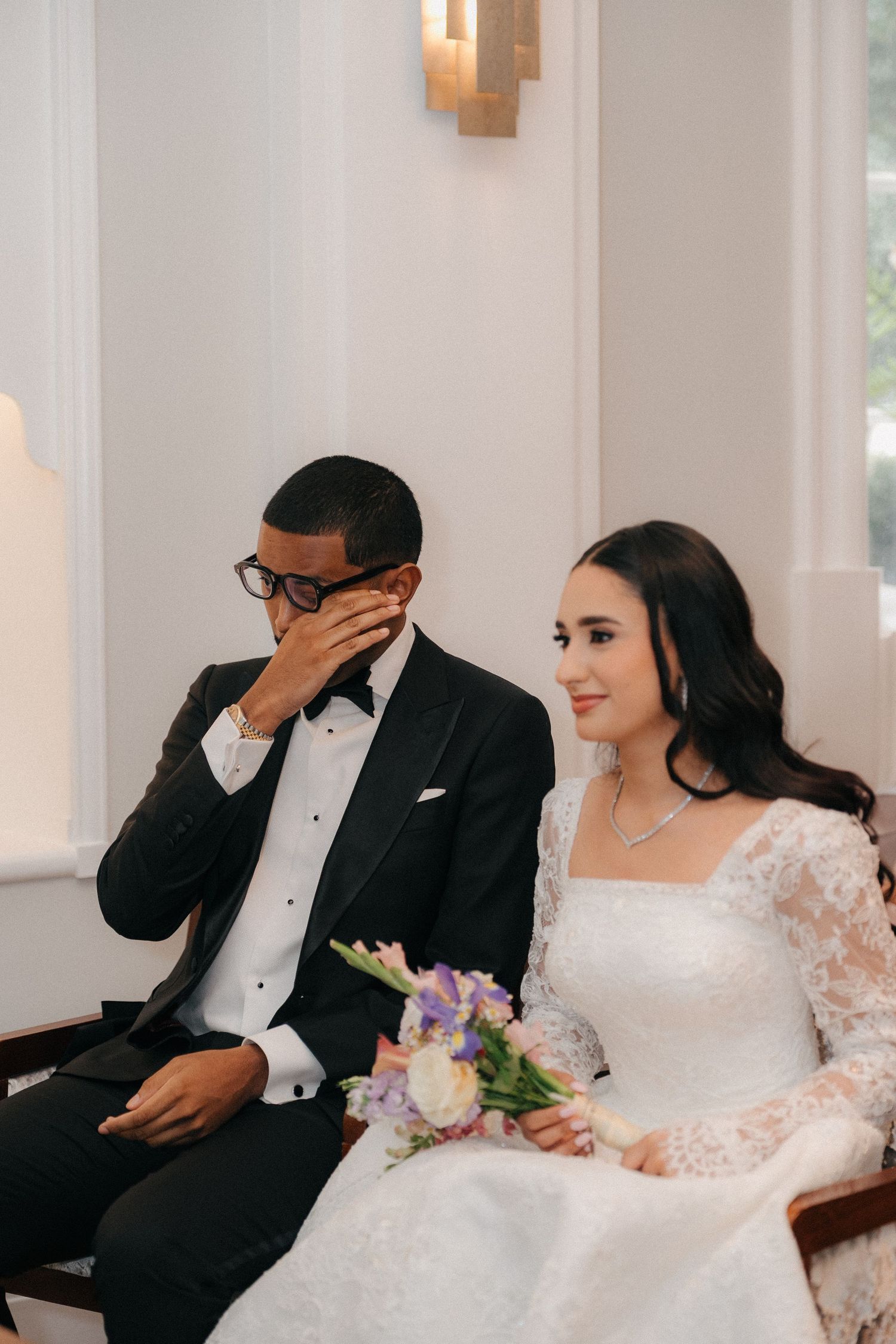 A newlywed couple shares emotional moments during their wedding ceremony.