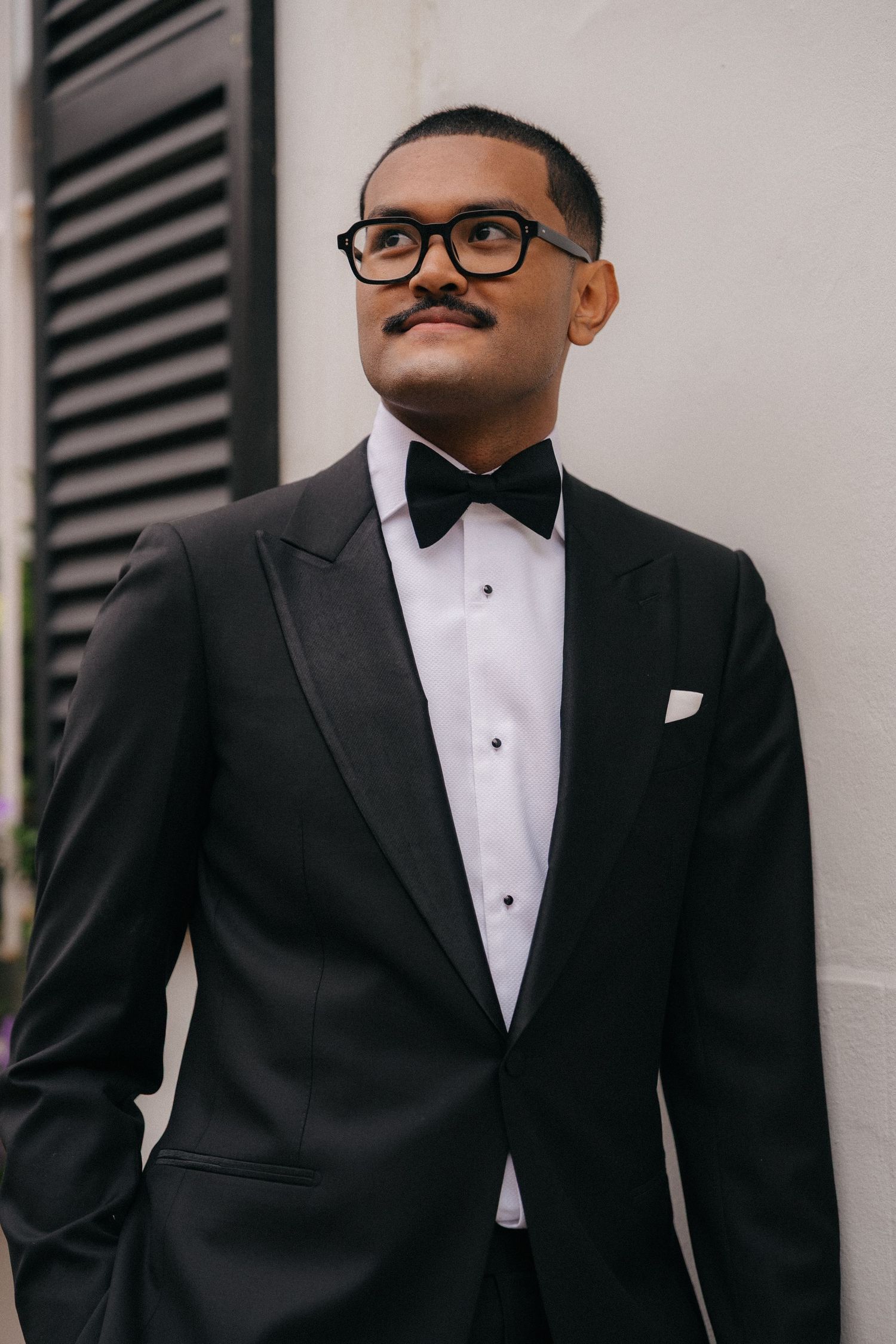 Classic groom portrait in black tuxedo and bow tie.
