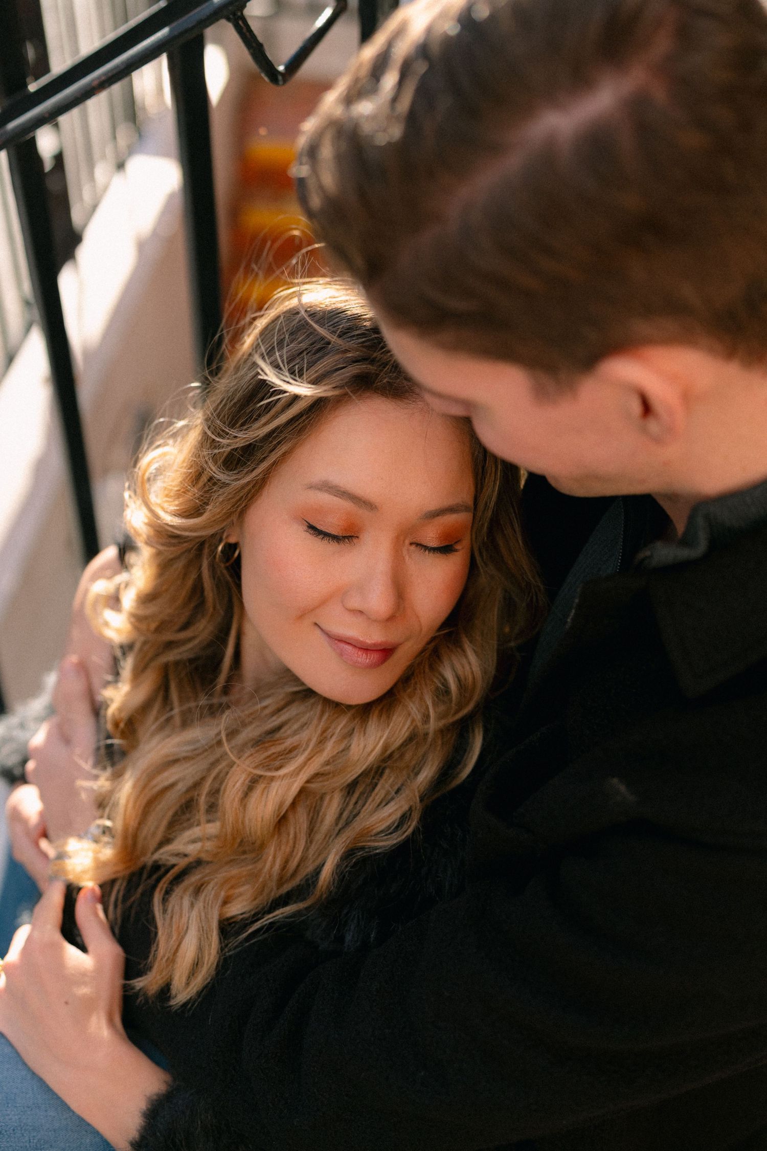 Tender moment captured between couple in warm lighting.