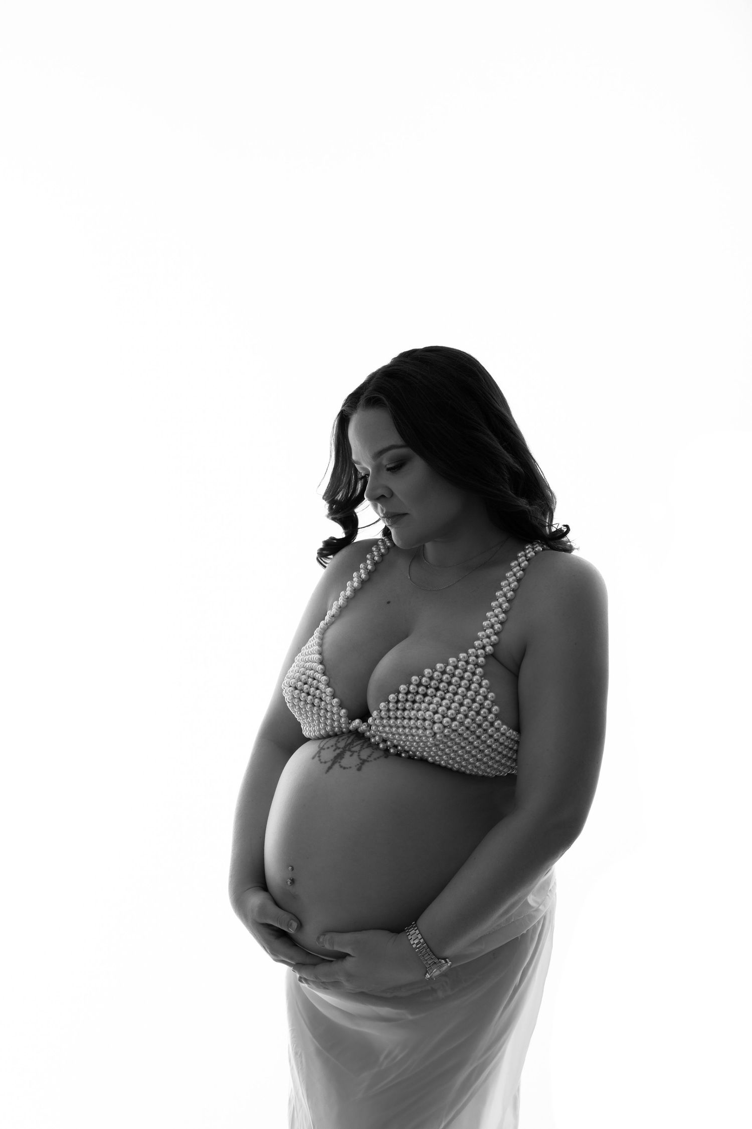 Black and white intimate maternity portrait with mother-to-be in polka dot bra.