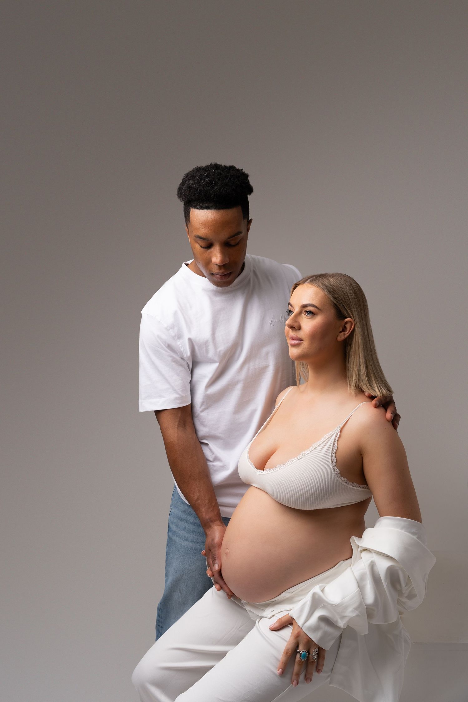 Intimate couple's maternity portrait showing tender moment between expectant parents.