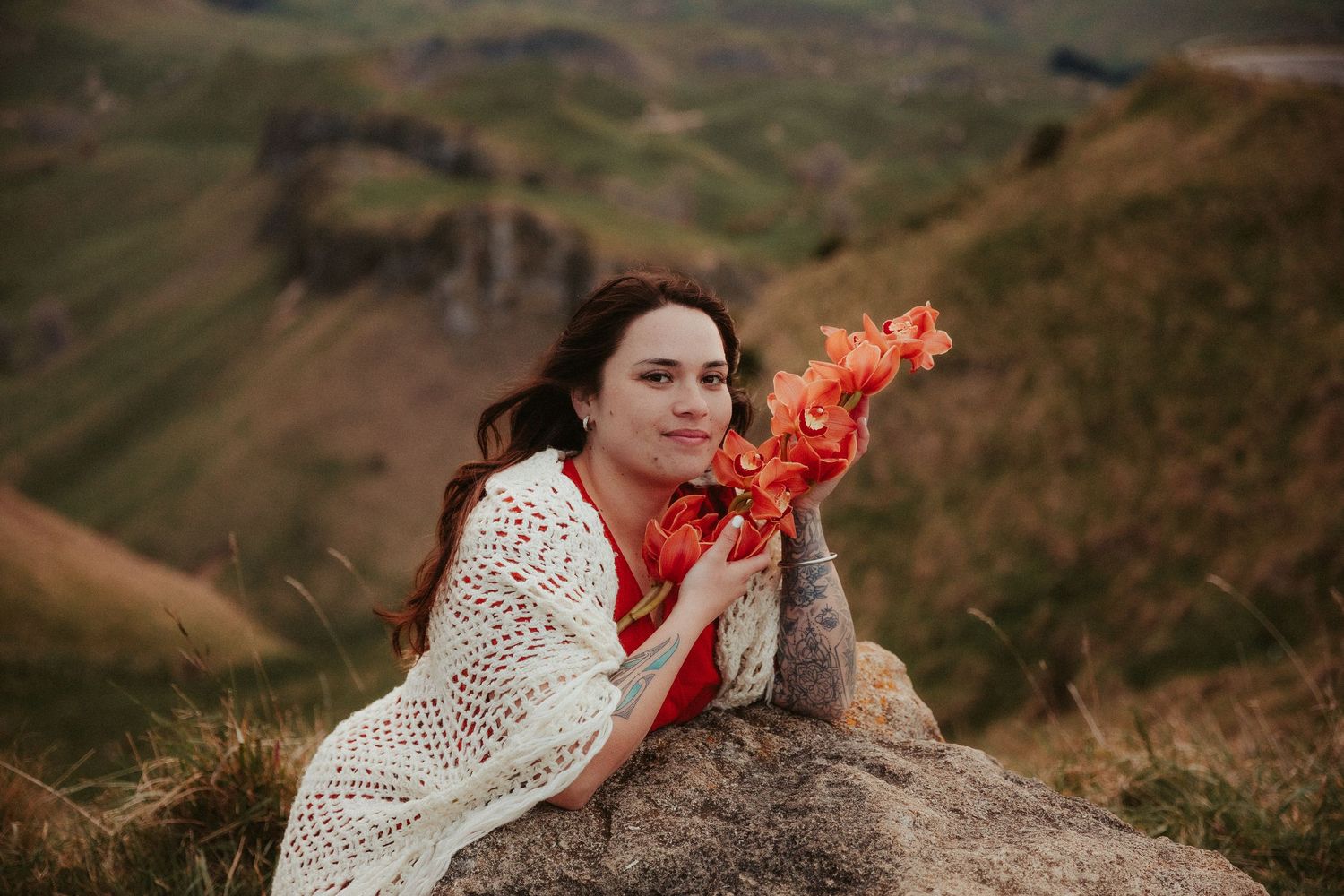 Outdoor portrait session on a hilltop featuring bright orange smoke effects.