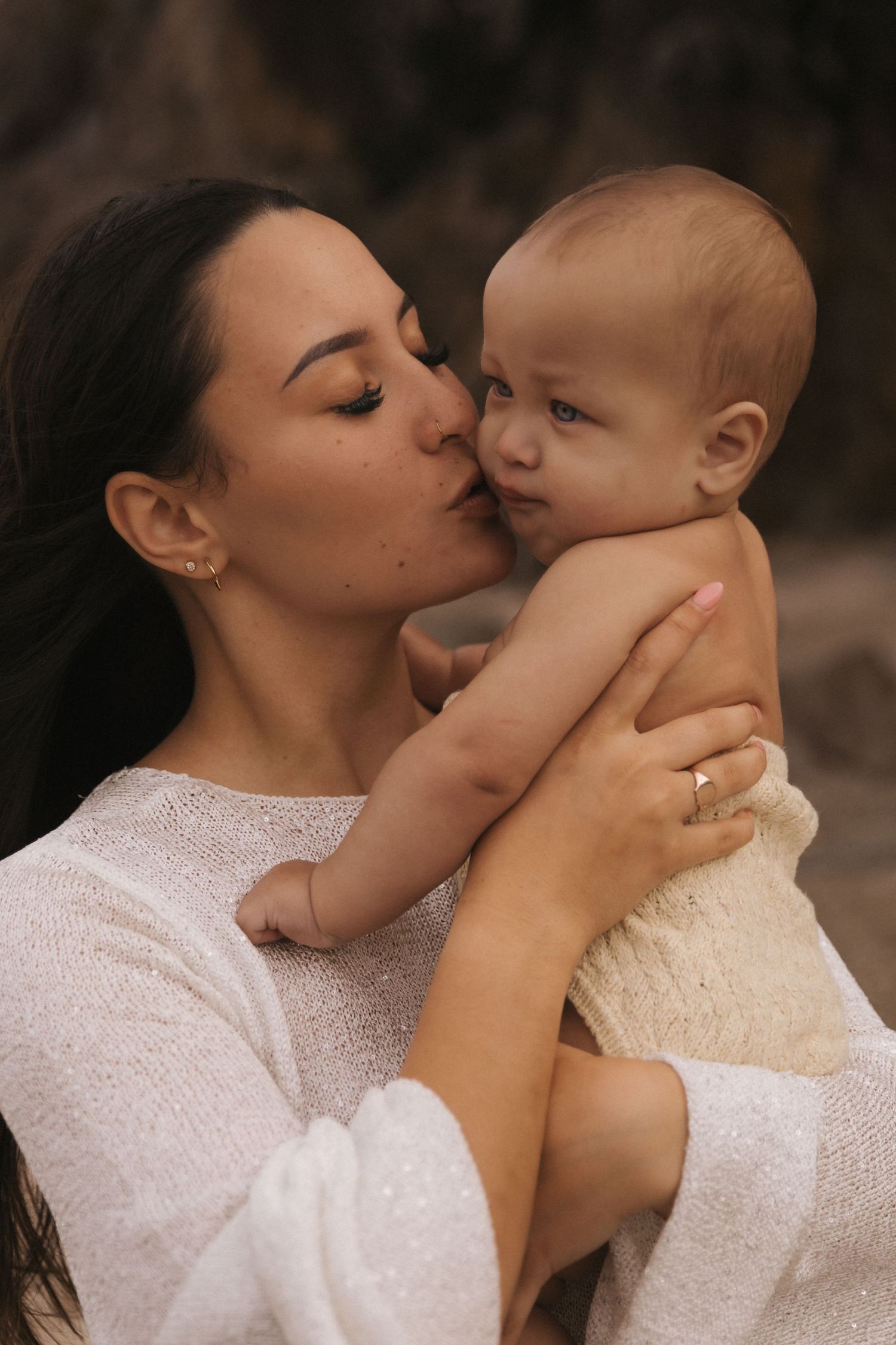 Intimate close-up moments captured in soft lighting with white lace details.