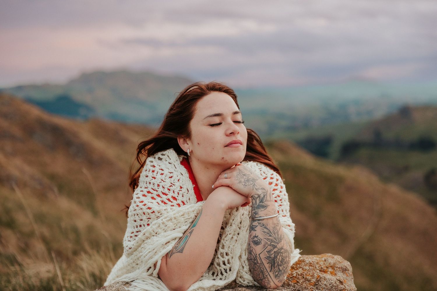 Artistic portraits captured against rolling hills and mountains in soft golden light.
