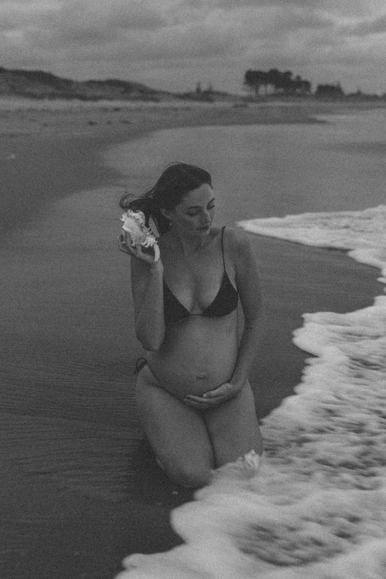 Black and white beach photography series with waves washing onto shore.