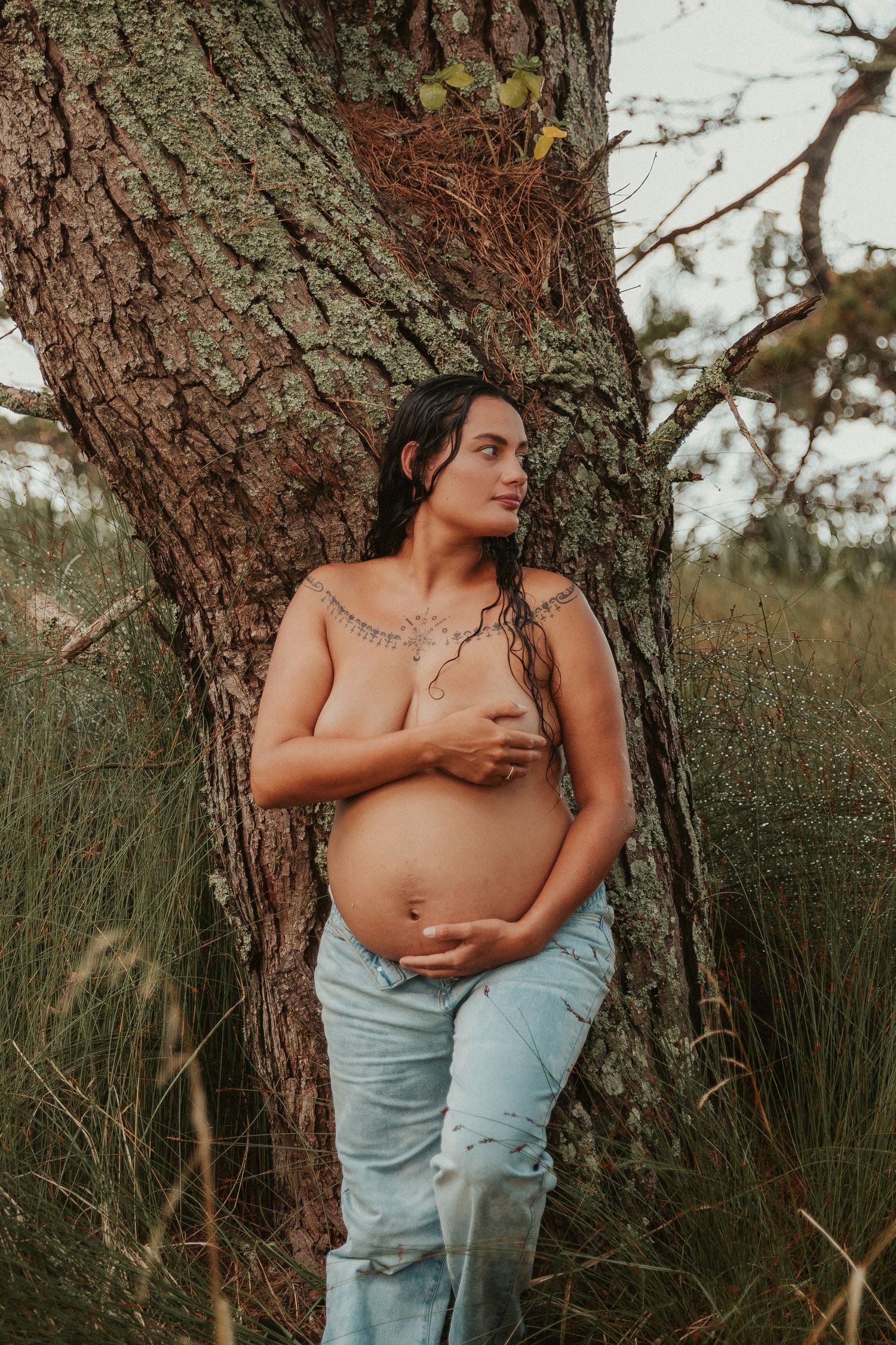 Artistic maternity photo series showing intimate moments against a tree trunk in a natural outdoor setting.