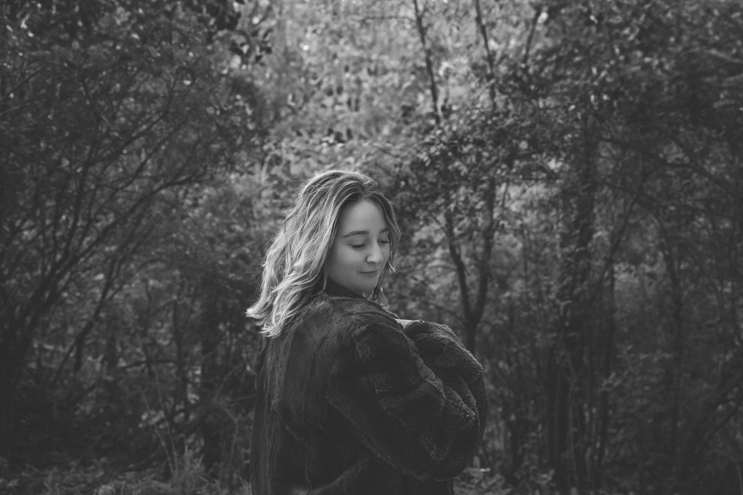 Black and white forest photography with dreamy, atmospheric composition.