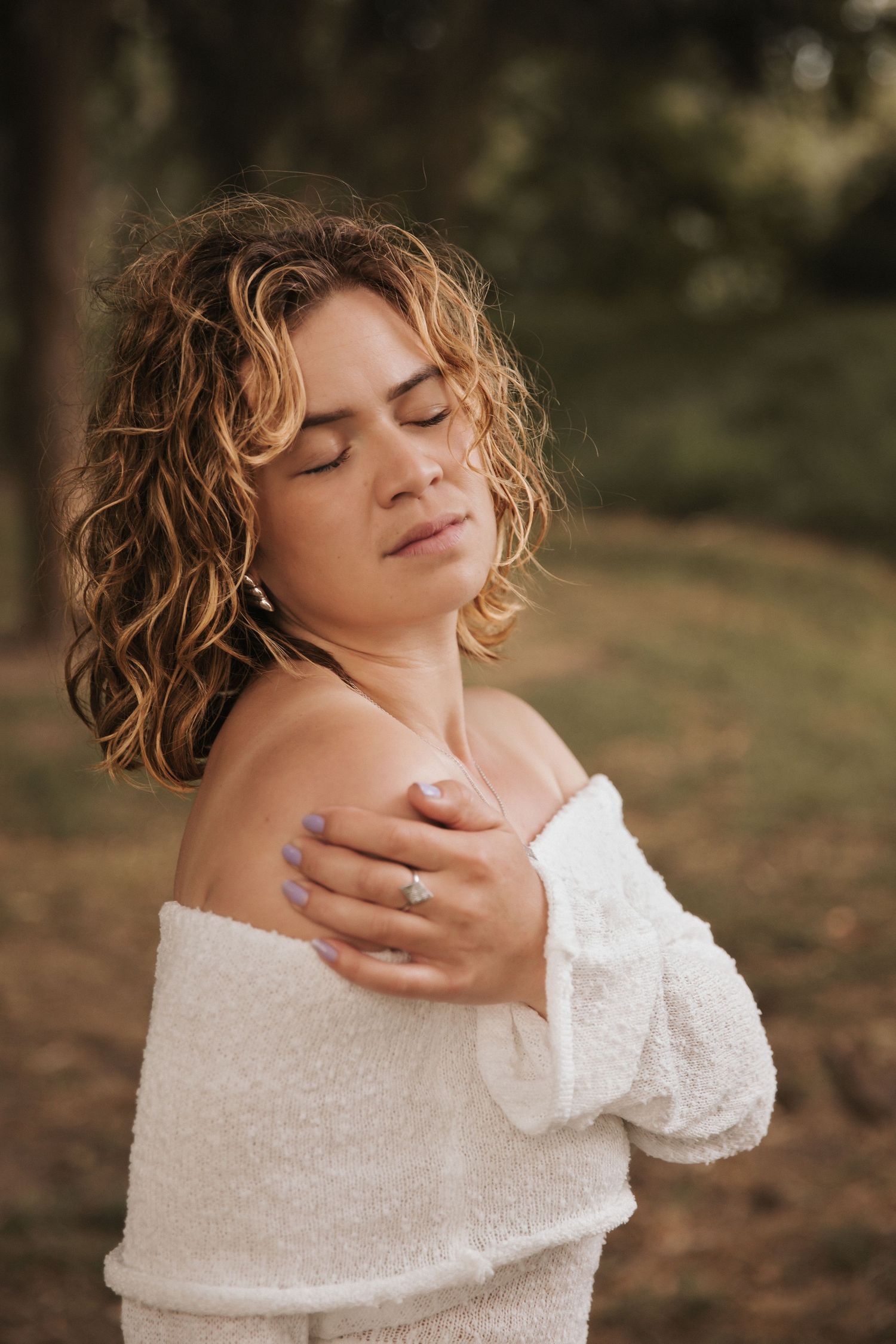 Intimate portrait sequence showing gentle poses in textured white sweater outdoors.