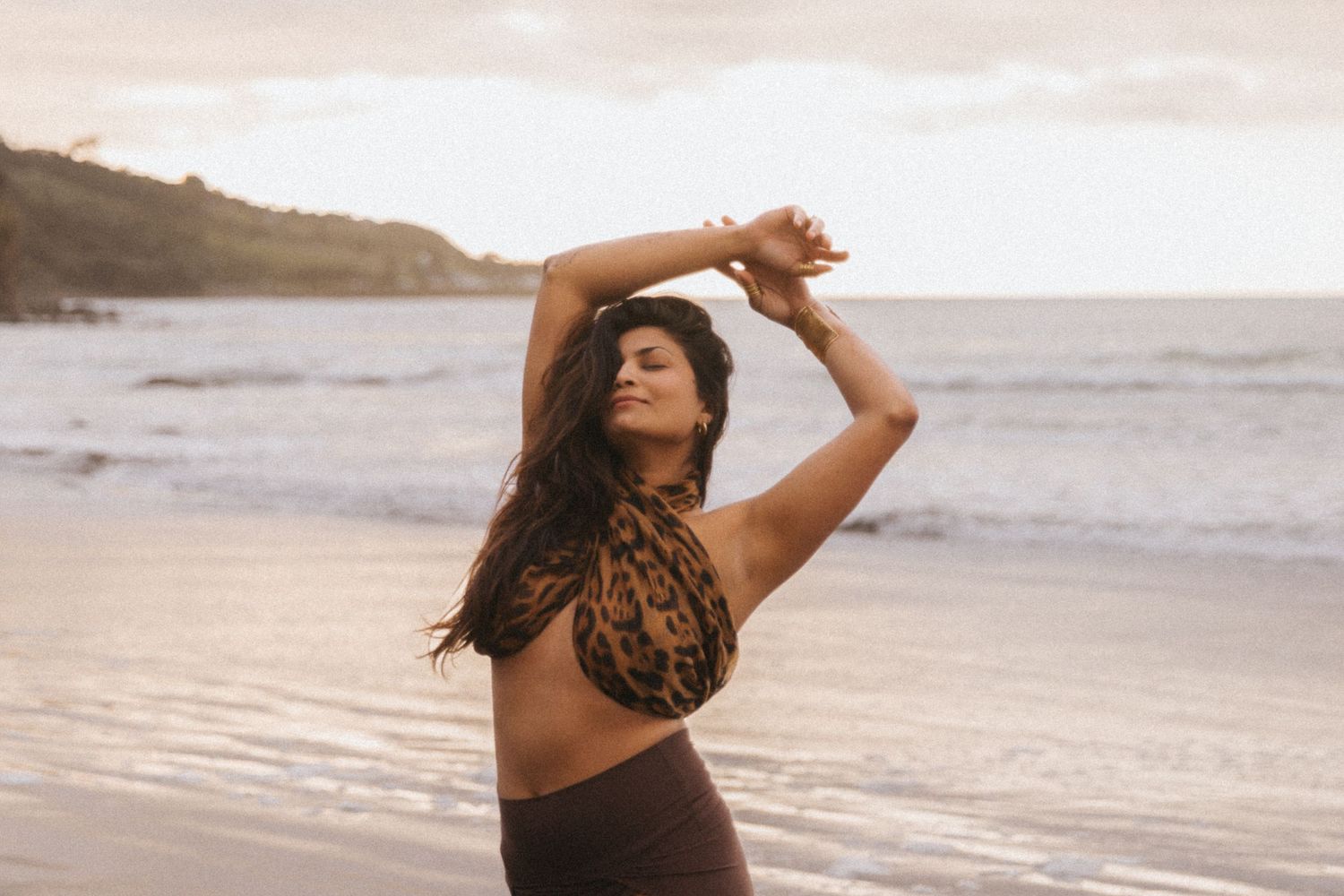 A series of beach lifestyle photos showing someone dancing and moving gracefully along the shoreline at sunset.