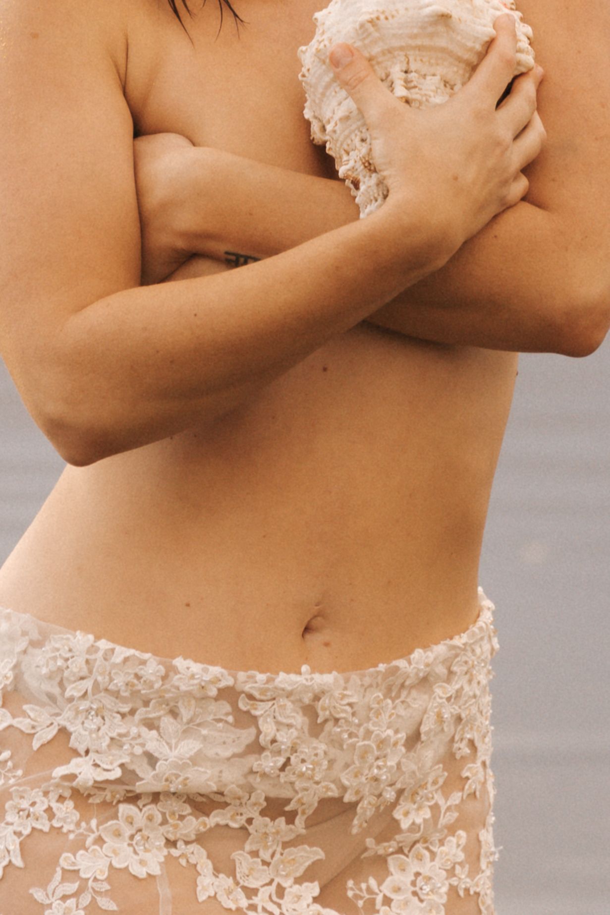 Close-up details of delicate lace and floral appliques on a dress bodice.