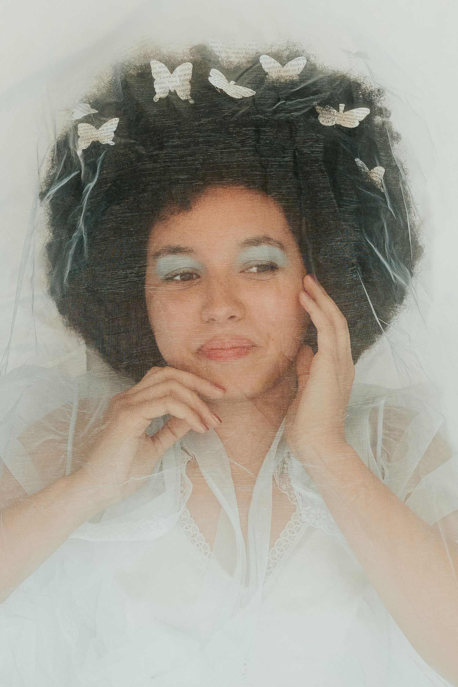 Dreamy portrait with white butterflies and natural curly hair.