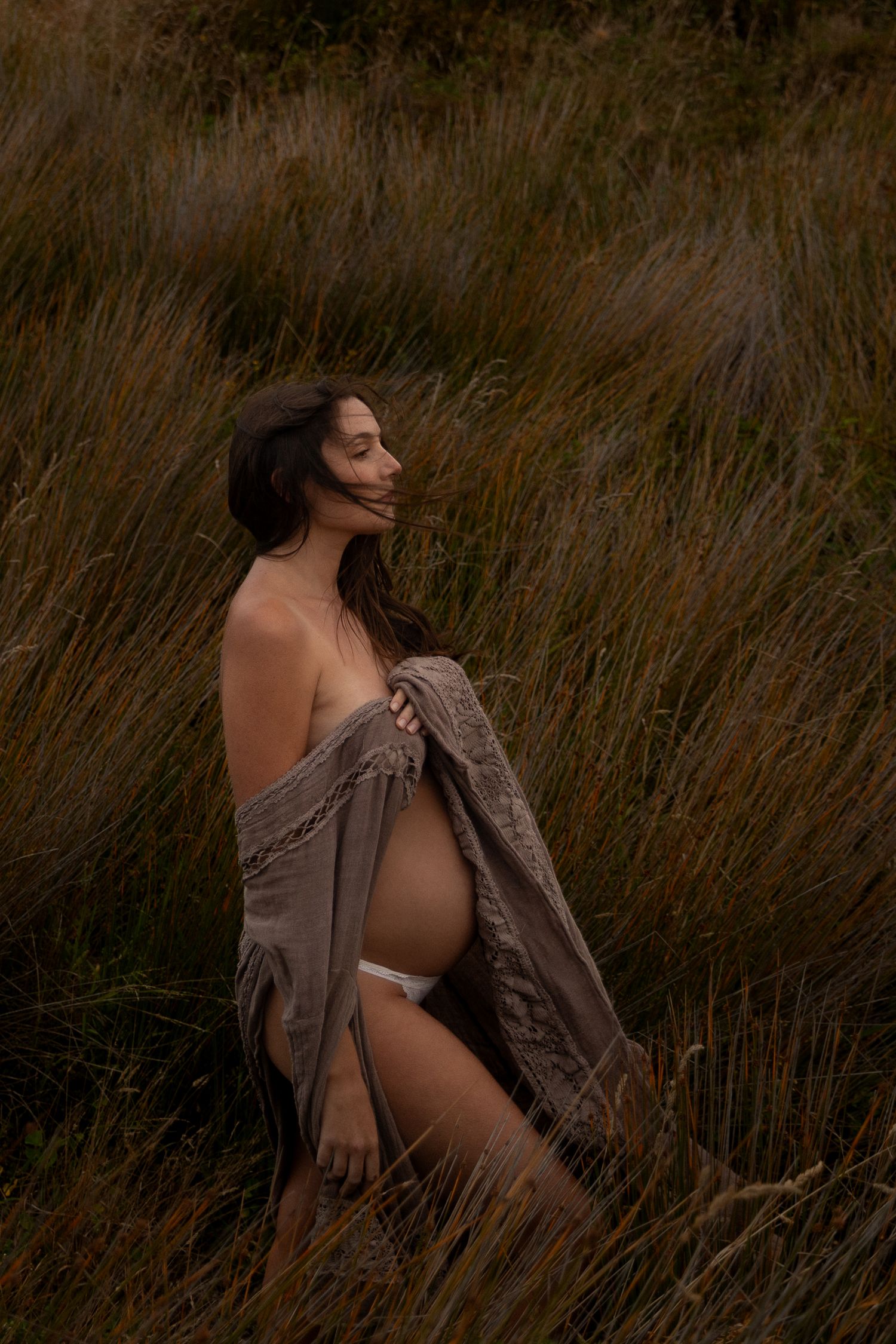 Artistic portrait series in tall grass during golden hour.