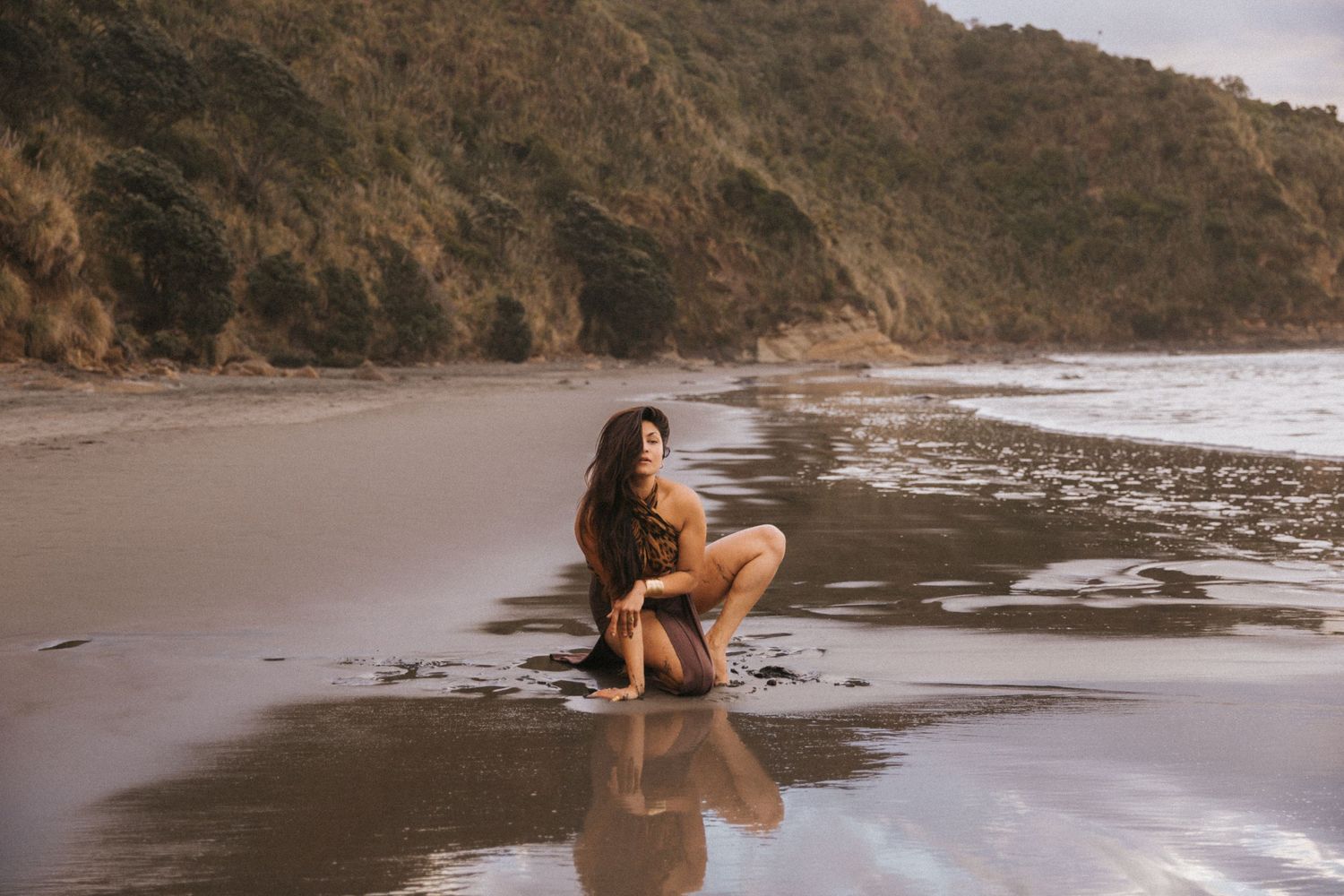 A series of beach photos showing a person in a black swimsuit posing on a sandy shoreline at sunset.