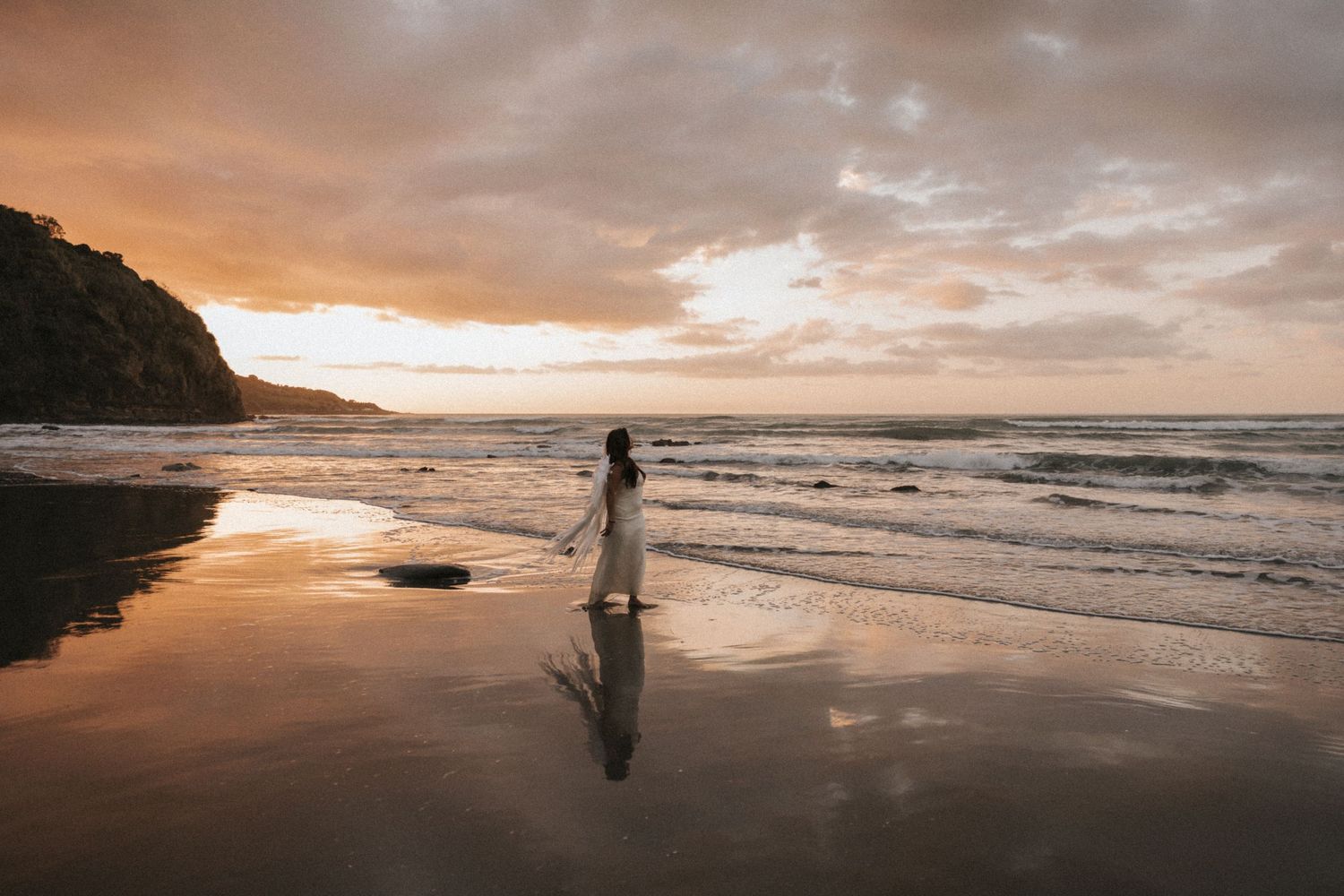 A series of connected sunset beach photos showing silhouettes walking along the shoreline at dusk.