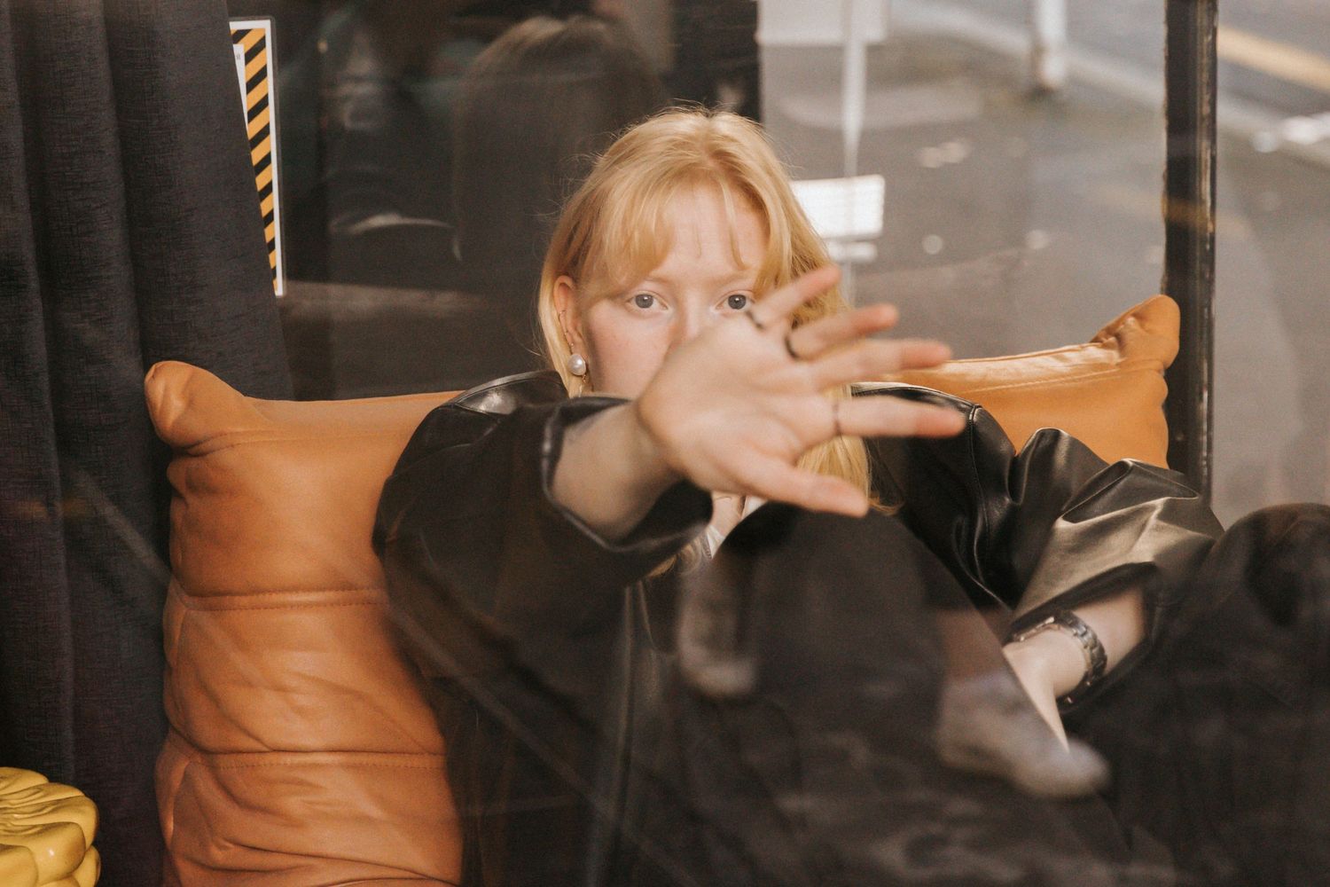 A sequence of six photos showing someone smoking a cigarette in a dimly lit indoor setting.