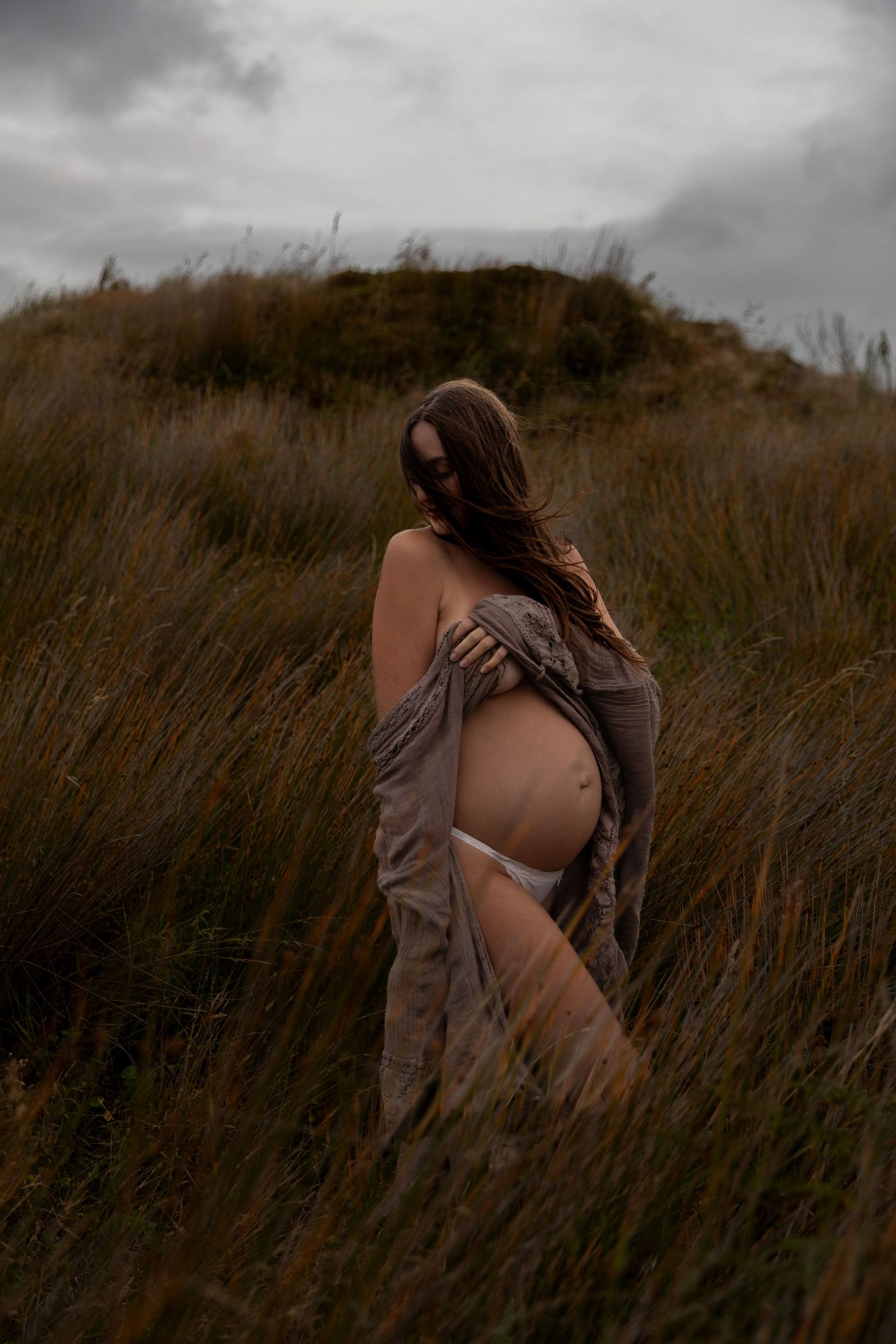 Dramatic black and white portrait series in wild grass field.