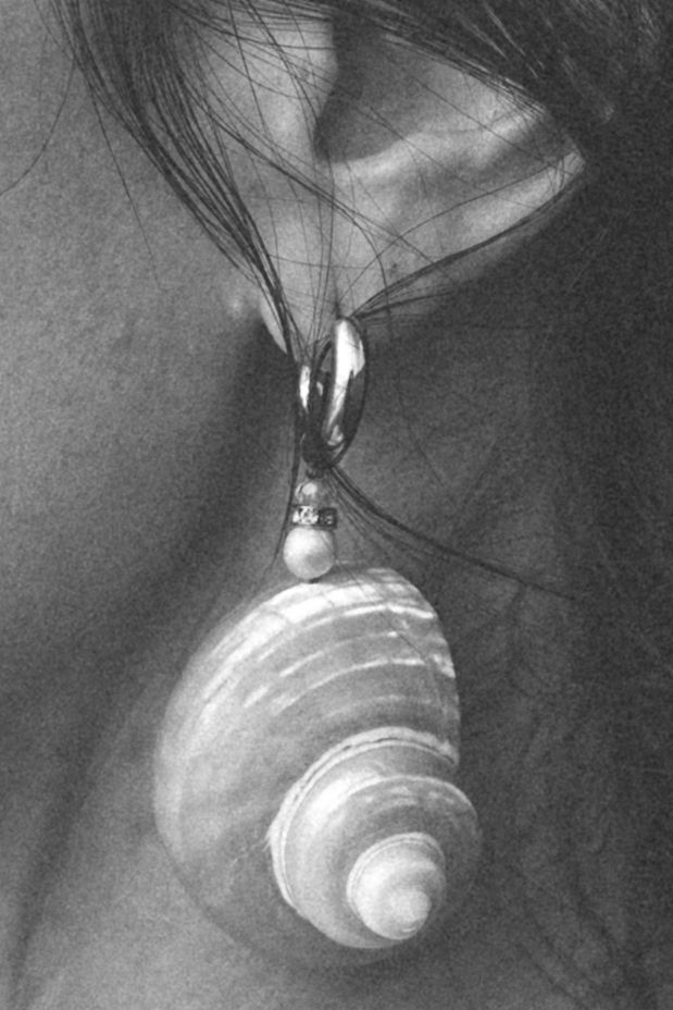Close-up black and white detail of pearl drop earring.