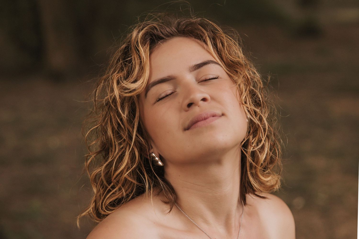 Serene outdoor portraits with soft lighting and delicate poses in white attire.