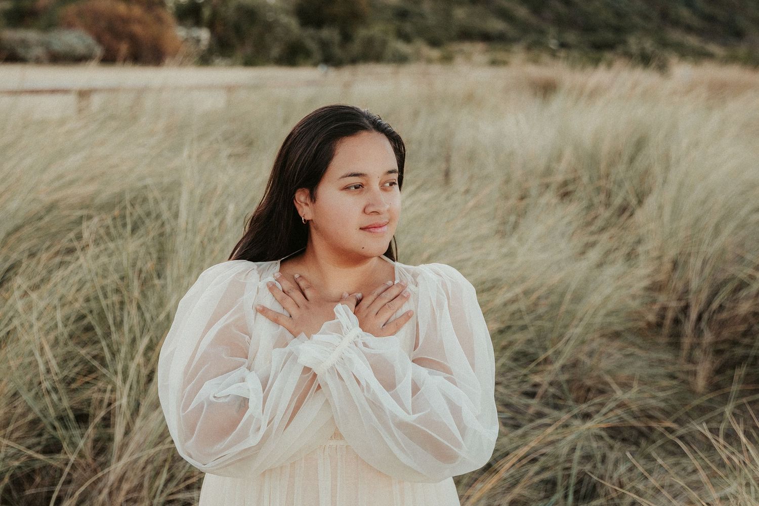 Artistic outdoor portraits with person in white sweater against natural backdrop.