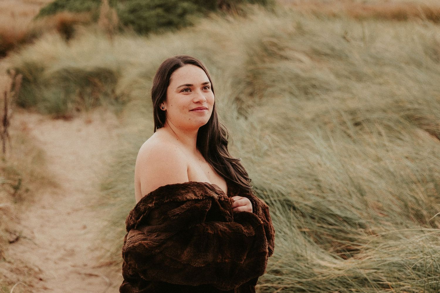 Dramatic beach photography featuring earthy colors and windswept coastal scenery.