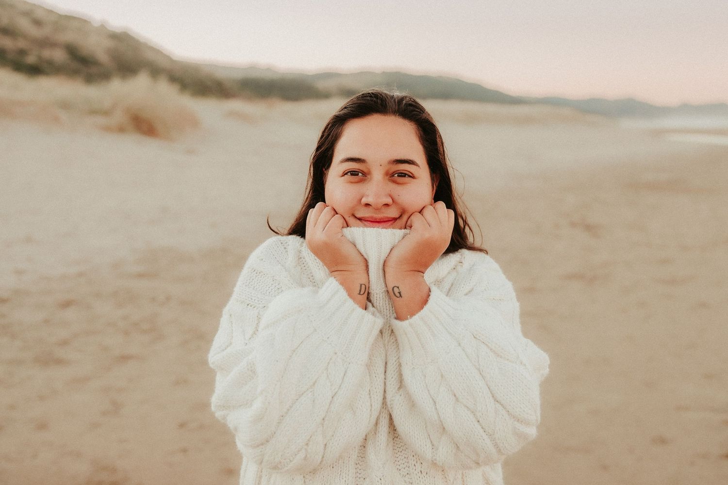 A person in a white dress poses playfully in multiple candid shots at a desert location during sunset.