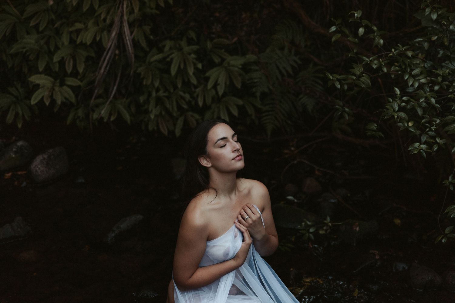 Moody portrait series with dark foliage and dramatic lighting effects.
