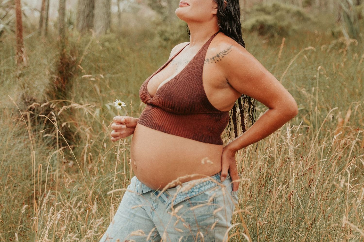 Artistic outdoor portrait among tall grass and natural scenery.