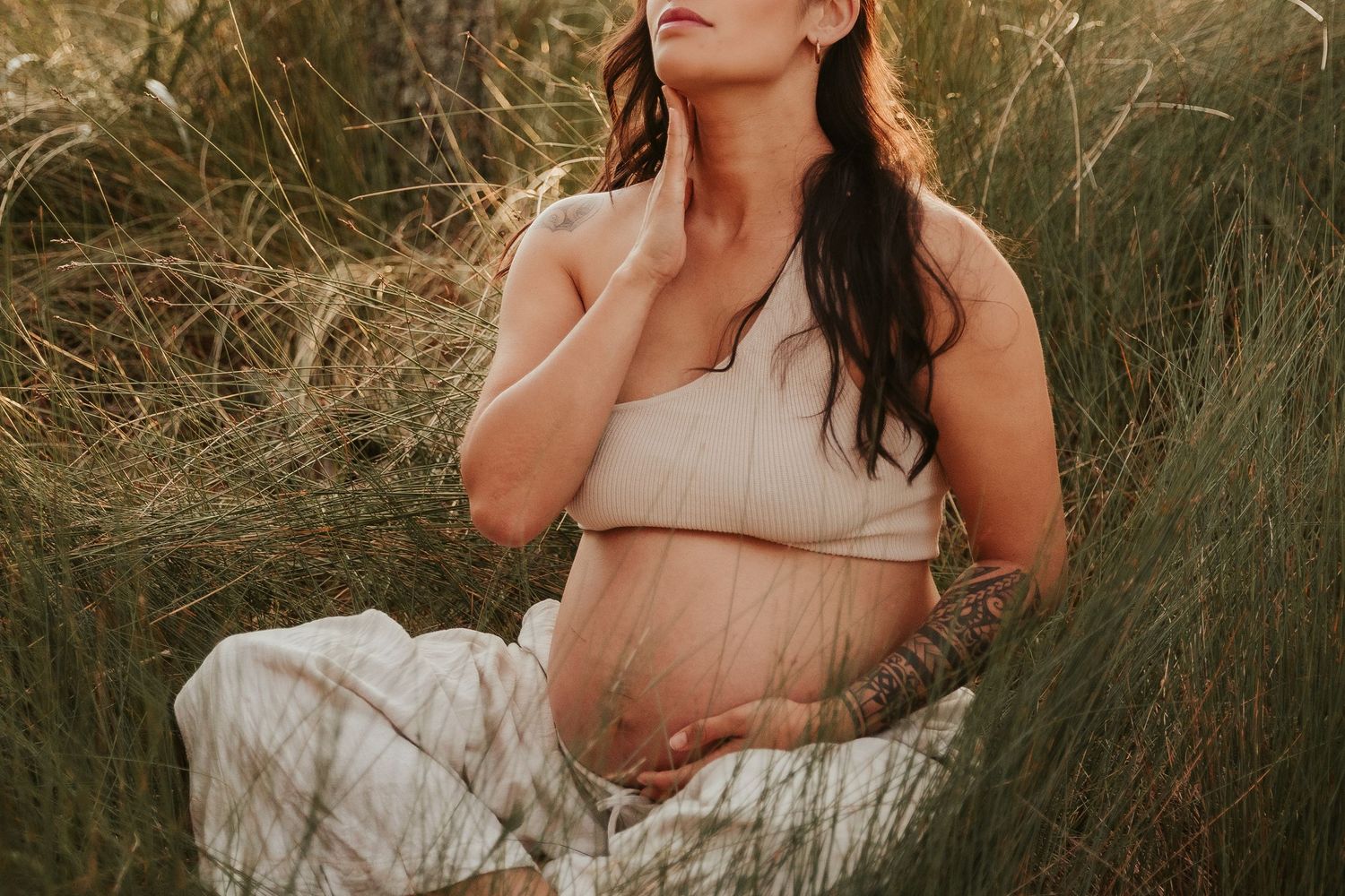 A dreamy portrait session in tall golden grass during sunset.