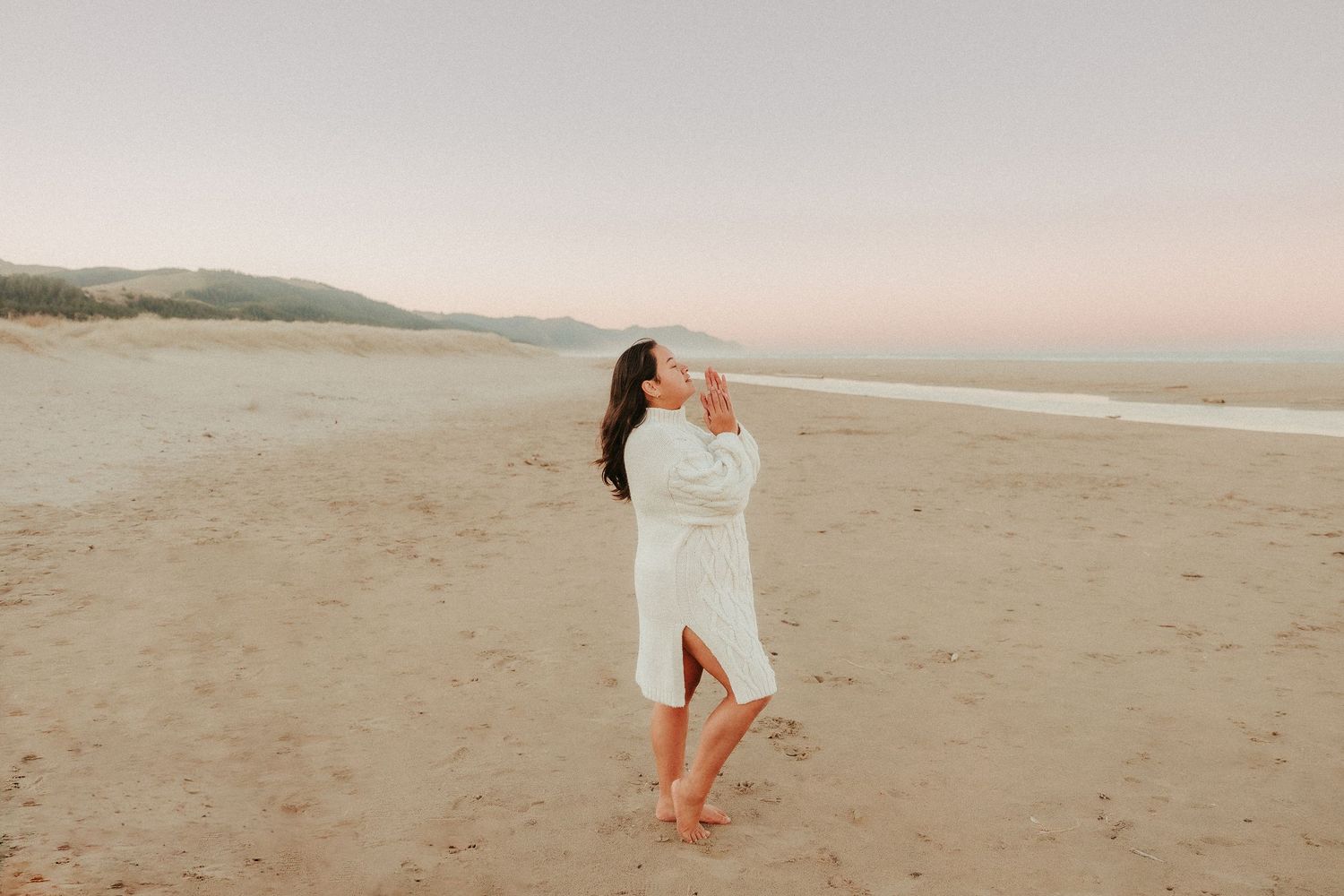 Ethereal beach scene with soft sandy tones at sunset.