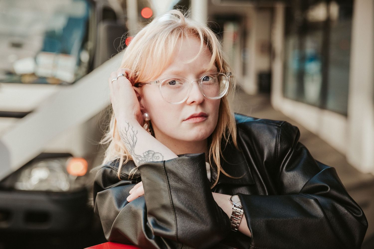 A series of candid lifestyle portraits showing someone with blonde hair in various casual poses against neutral backgrounds.