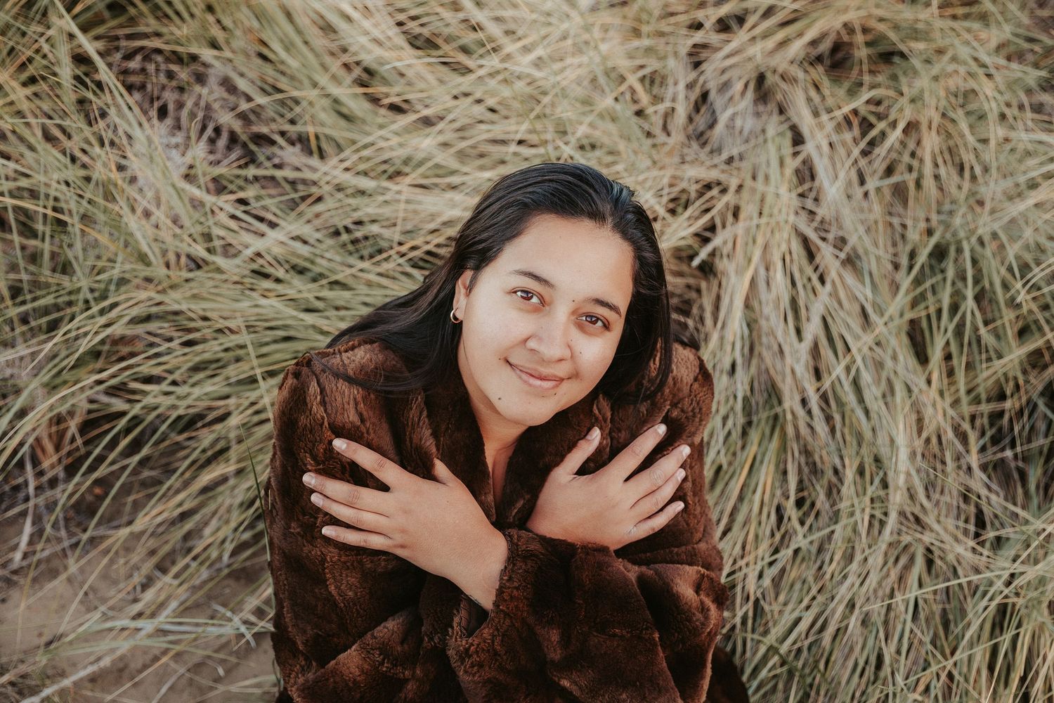 Artistic outdoor portrait series with natural grass backdrop and soft lighting.