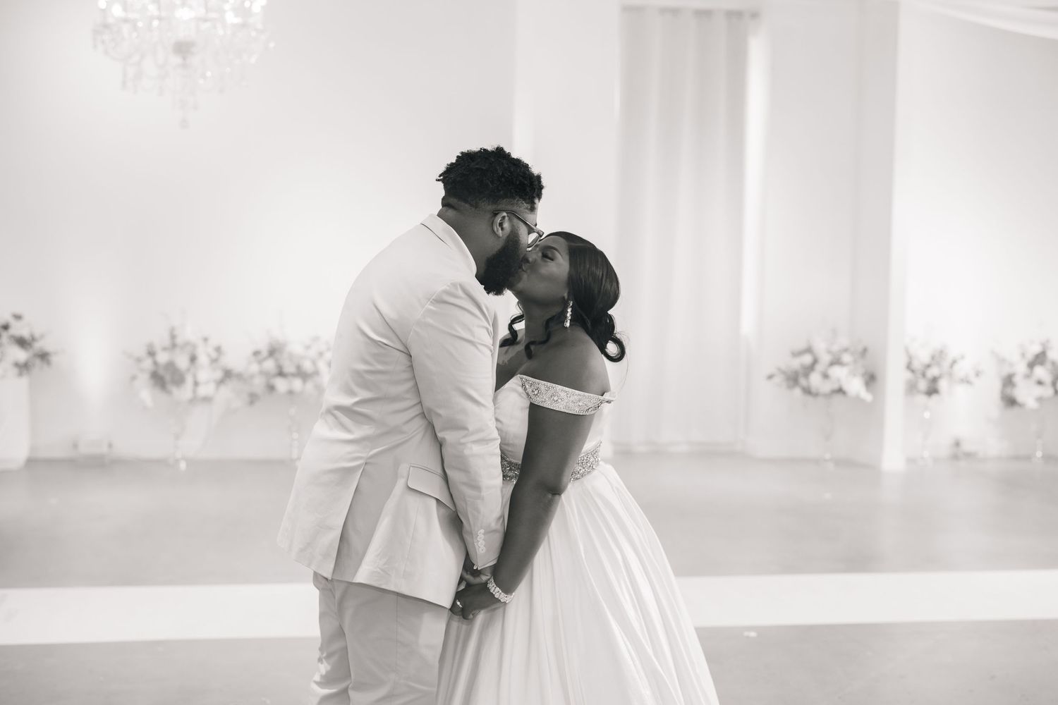 A romantic black and white wedding photo sequence showing a couple dancing and embracing on their special day.