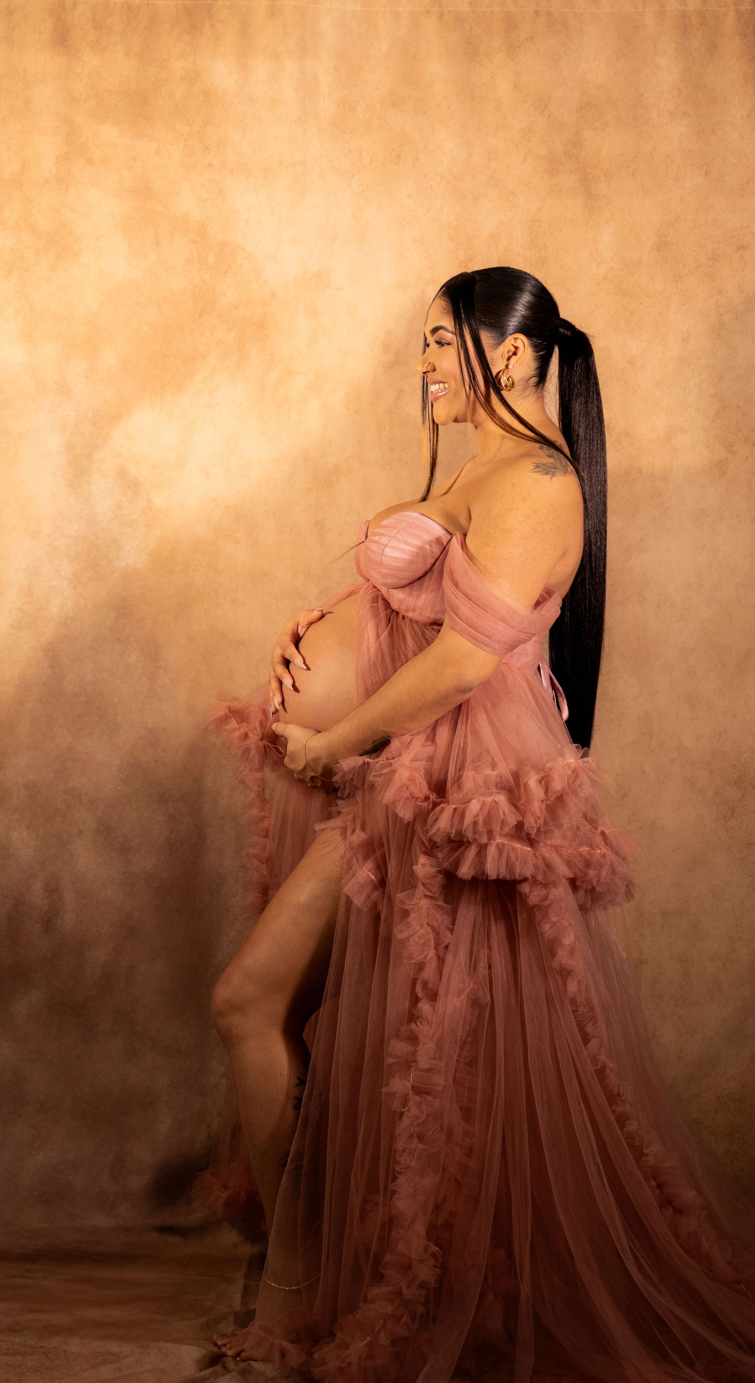 Ethereal mauve ruffled tulle gown captured in artistic studio portraits against textured bronze backdrop.