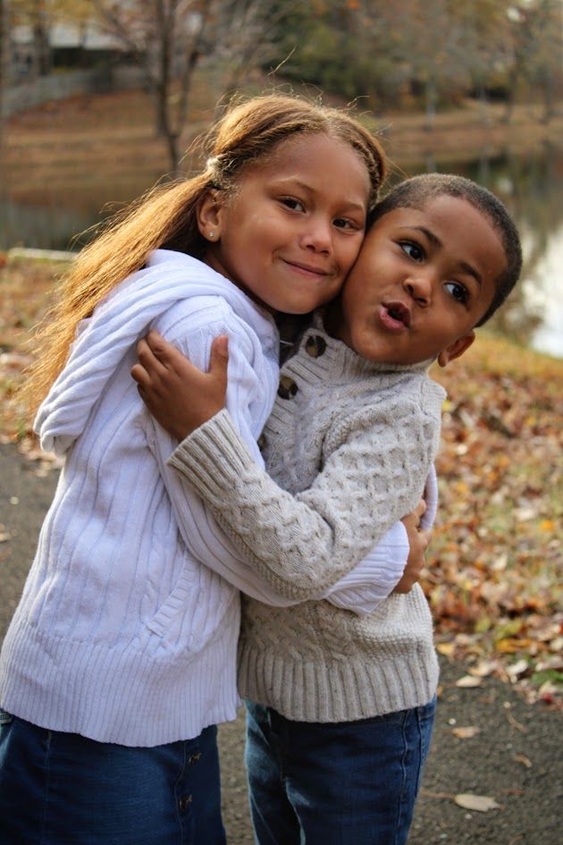 Sweet candid moments captured between two in cozy white sweaters during autumn.