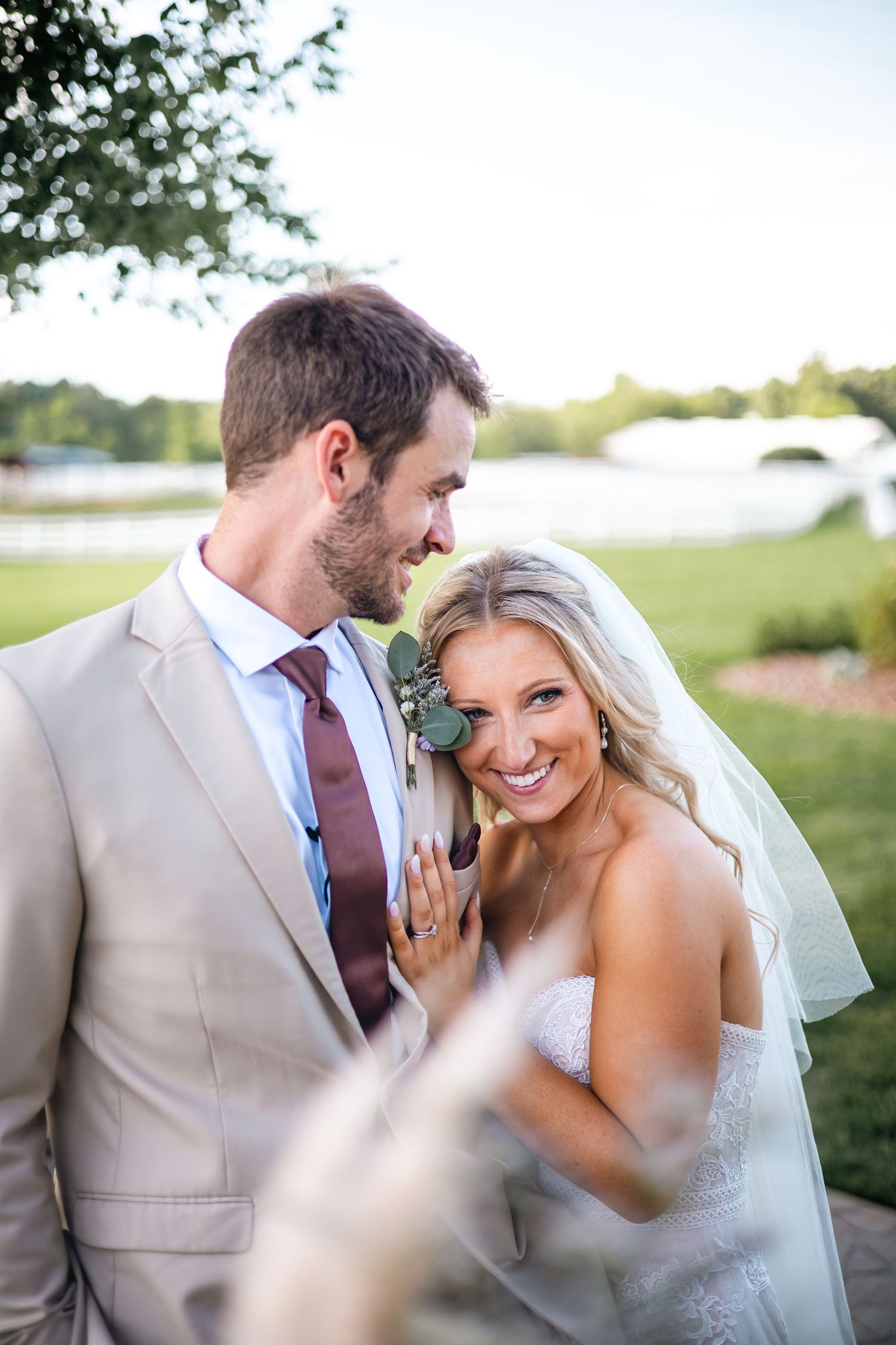 A couple shares joyful moments together outdoors on their wedding day.