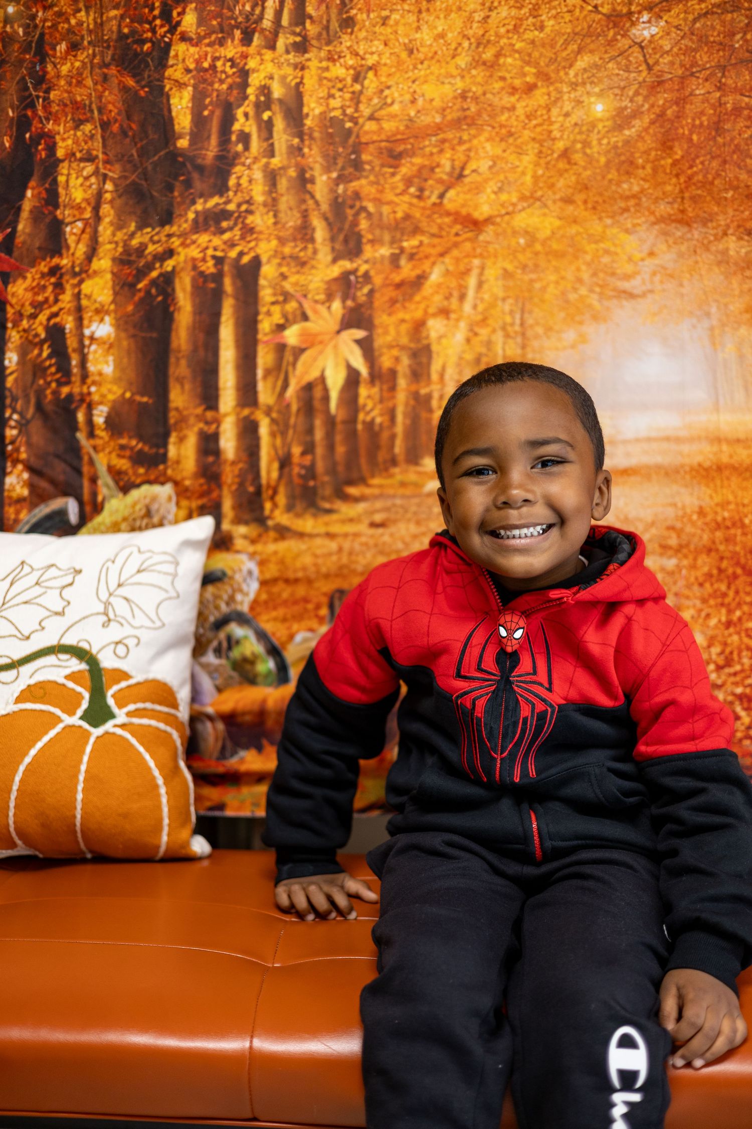 A series of fall-themed photos showing someone in a red and black Spider-Man jacket against an autumn backdrop with orange leaves.