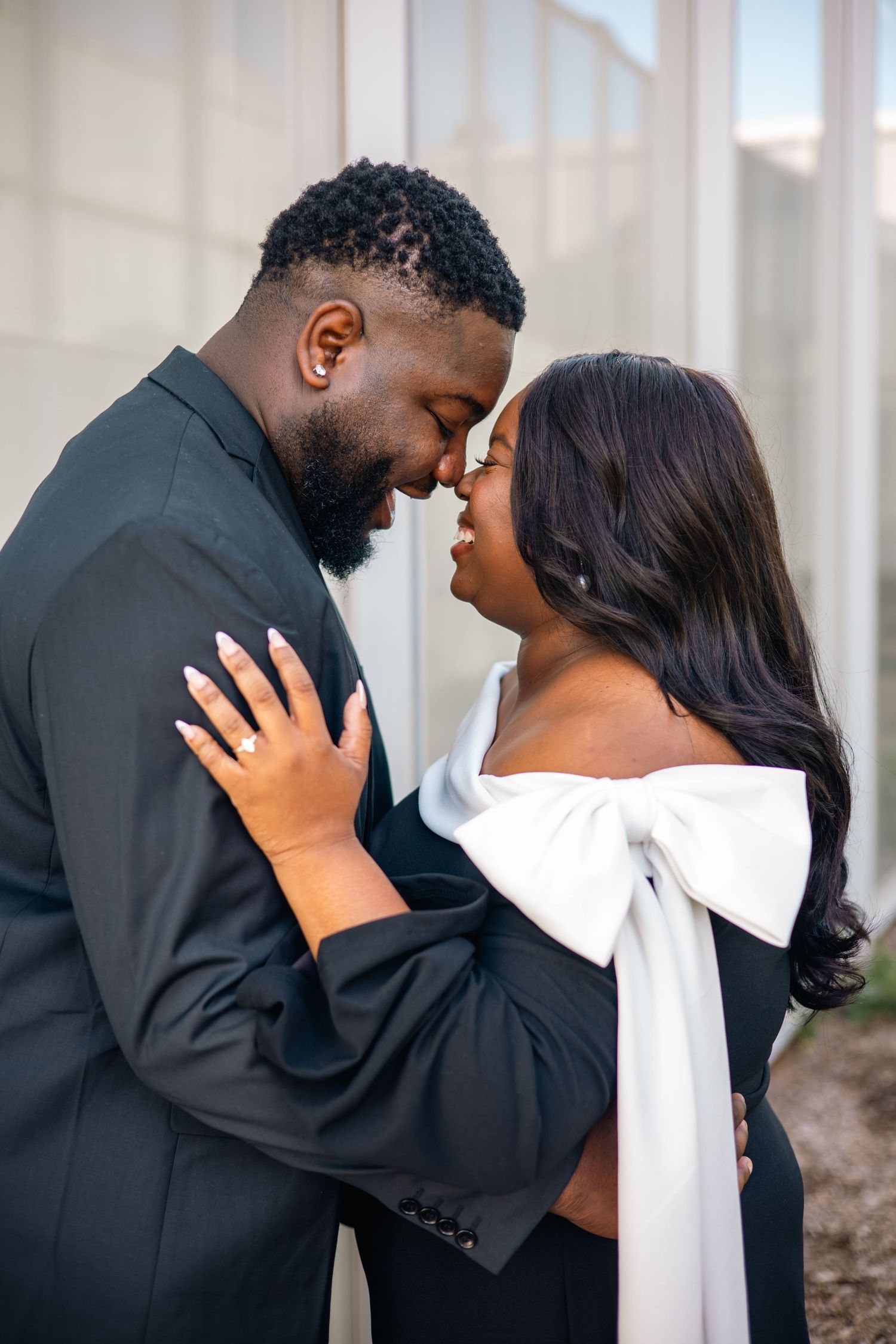 A romantic couple shares tender moments in a series of black and white engagement photos.