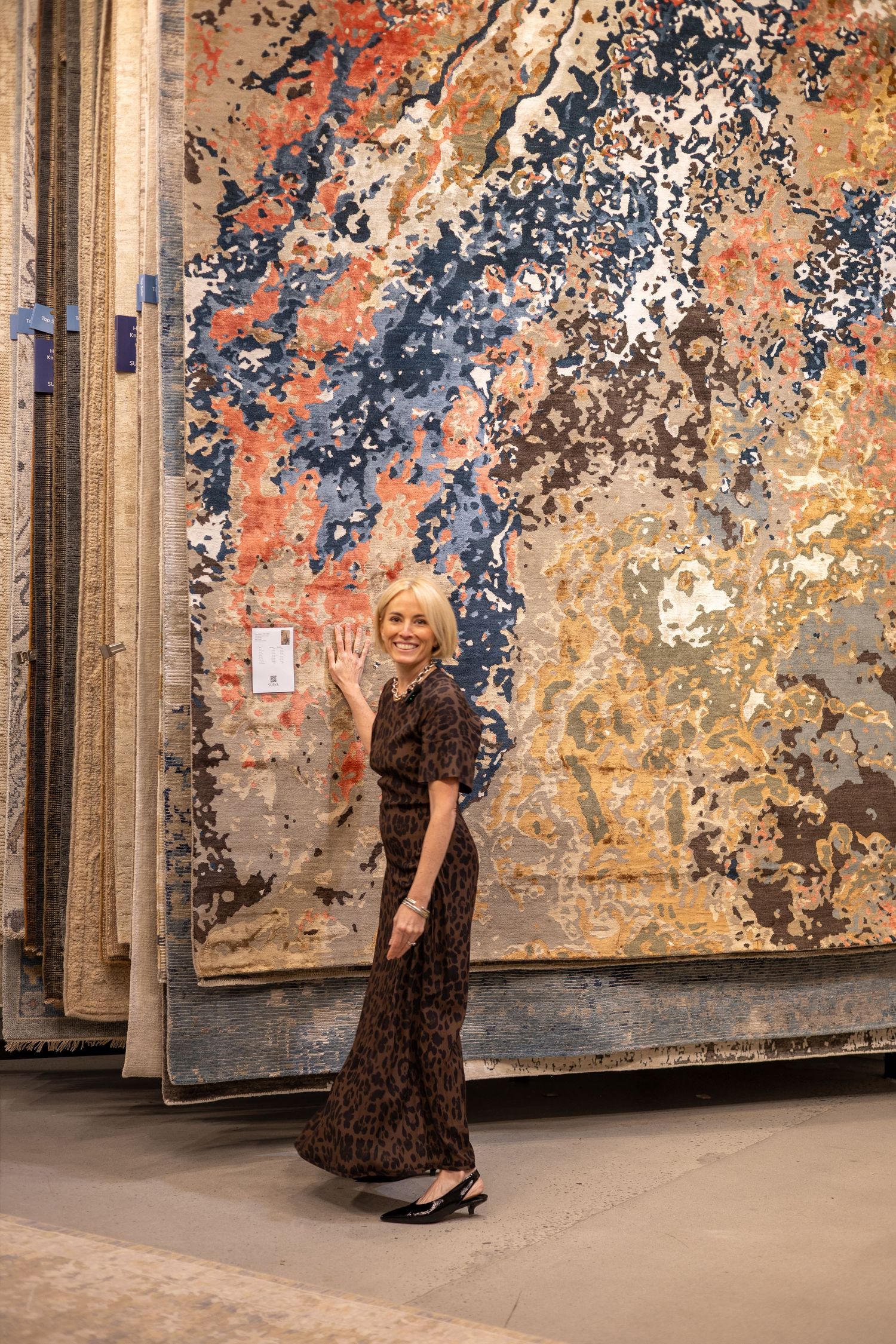 Fashion photos taken against a vibrant wall with peeling paint showing orange, blue and beige tones.