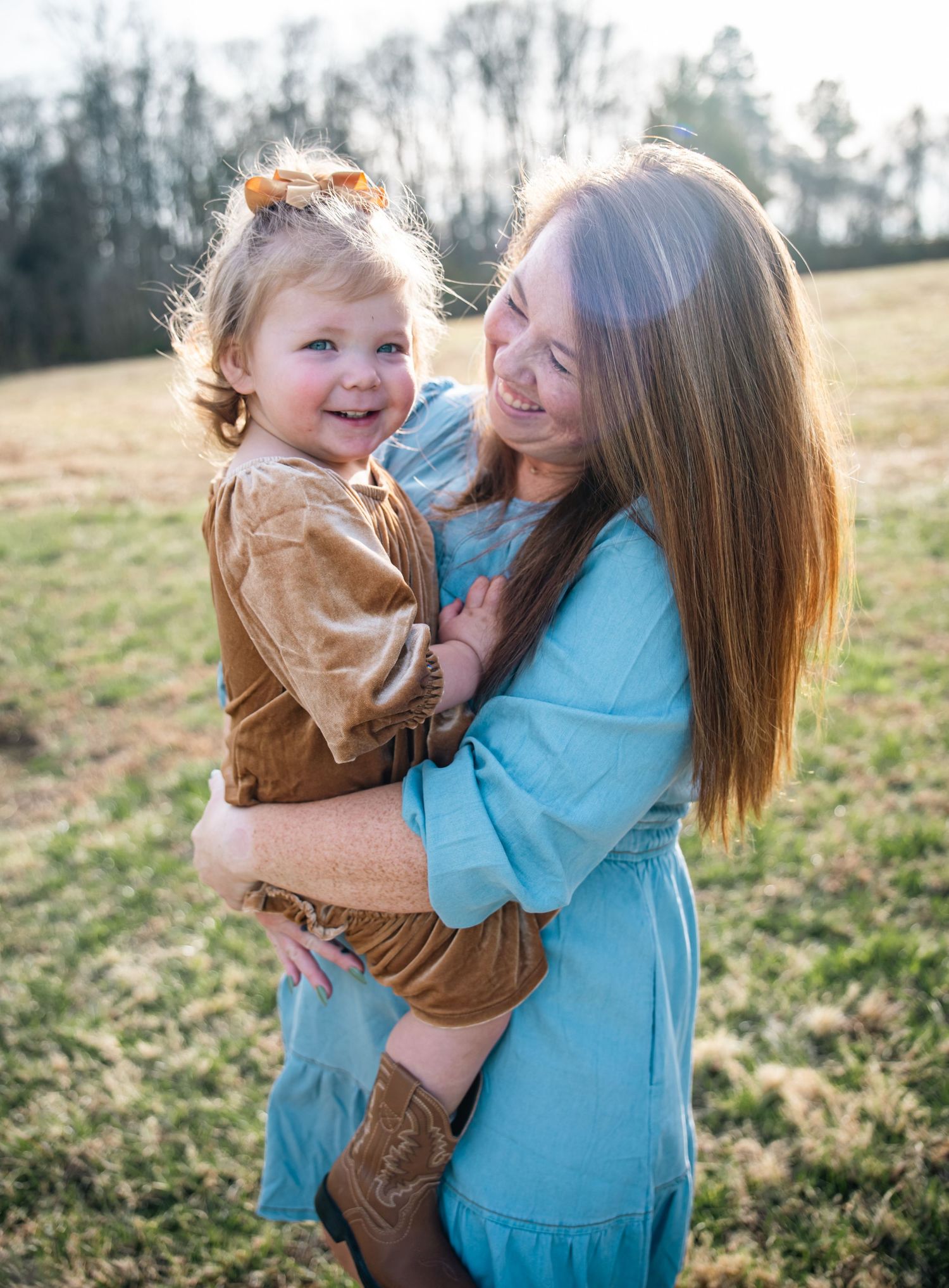 A heartwarming series of candid moments captured outdoors in a grassy field on a sunny afternoon.