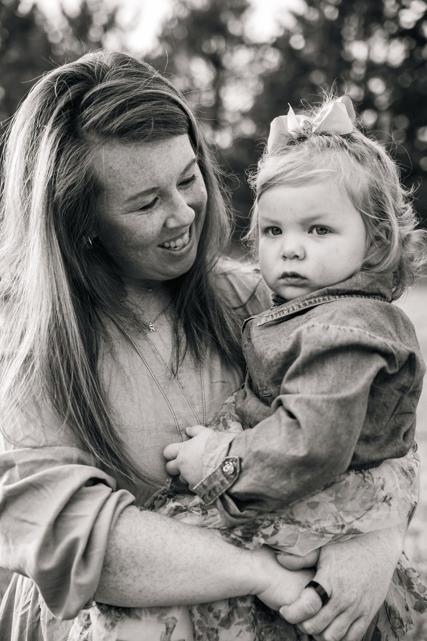 Candid black and white sequence captures playful interaction between adult and child outdoors.