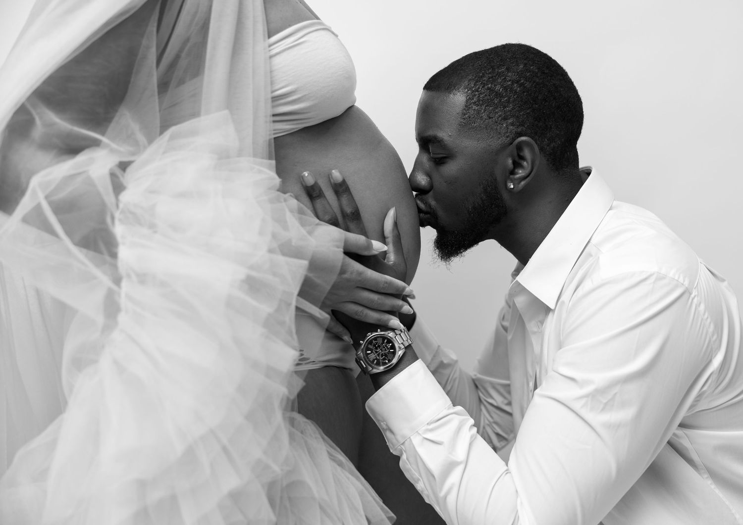 A romantic black and white photo series showing tender moments between a bride and groom on their wedding day.