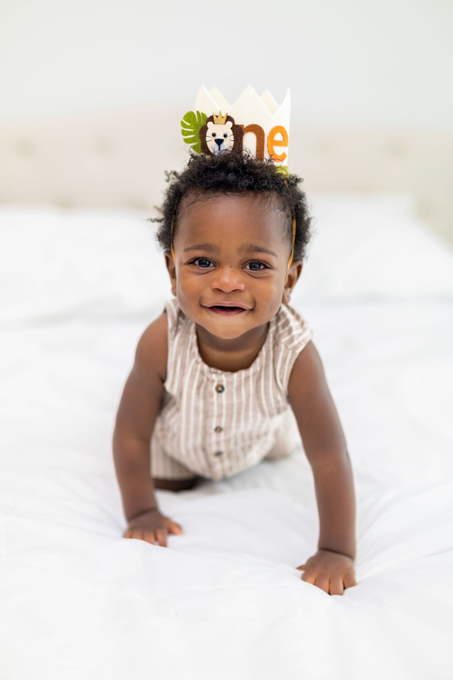 Smiling baby wearing a safari-themed 