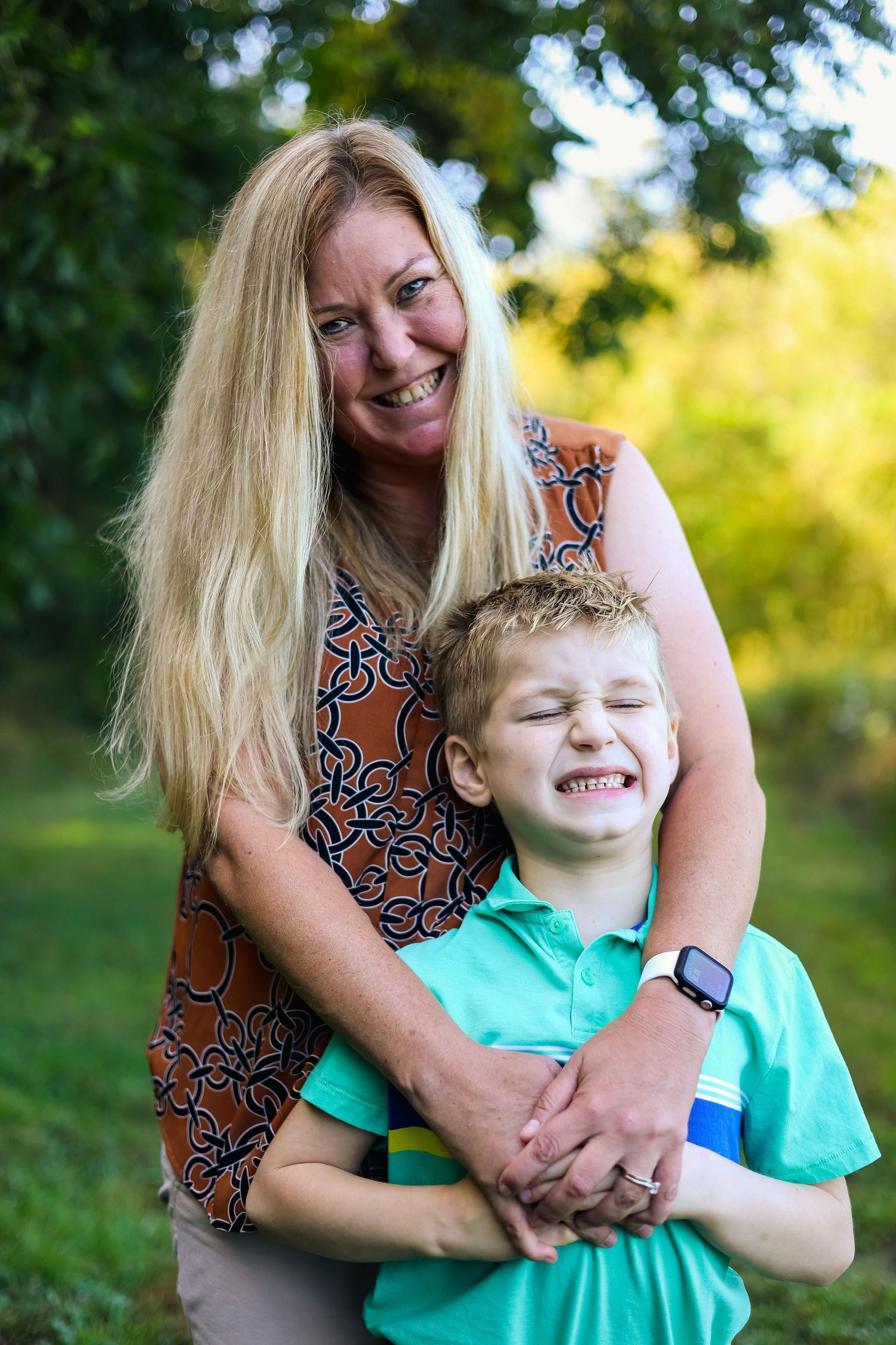 A series of candid outdoor photos showing joyful laughter and embraces against a sunlit natural background.