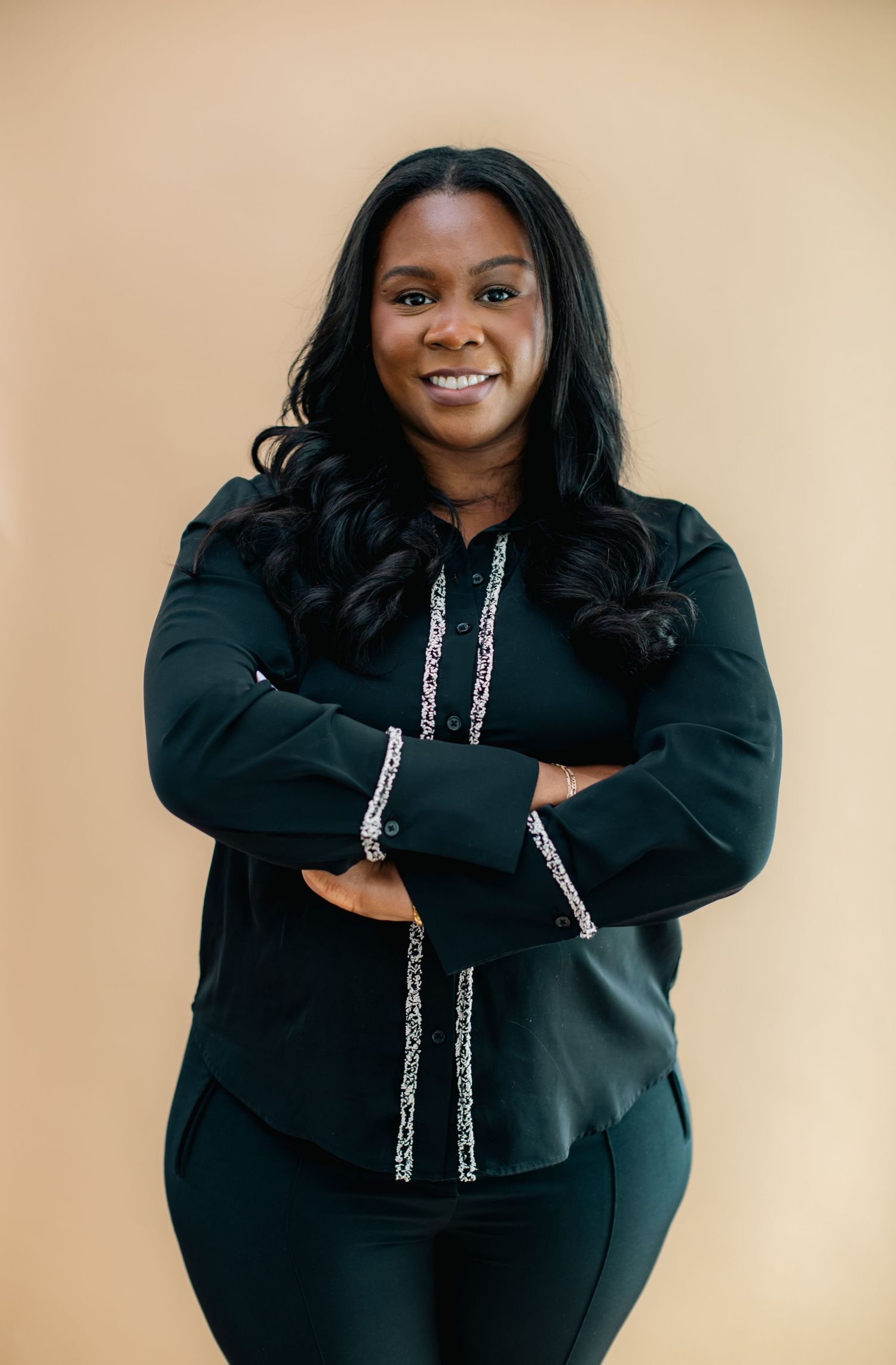 A series of fashion portraits showing someone in a black hoodie sweatshirt posing against a beige background.