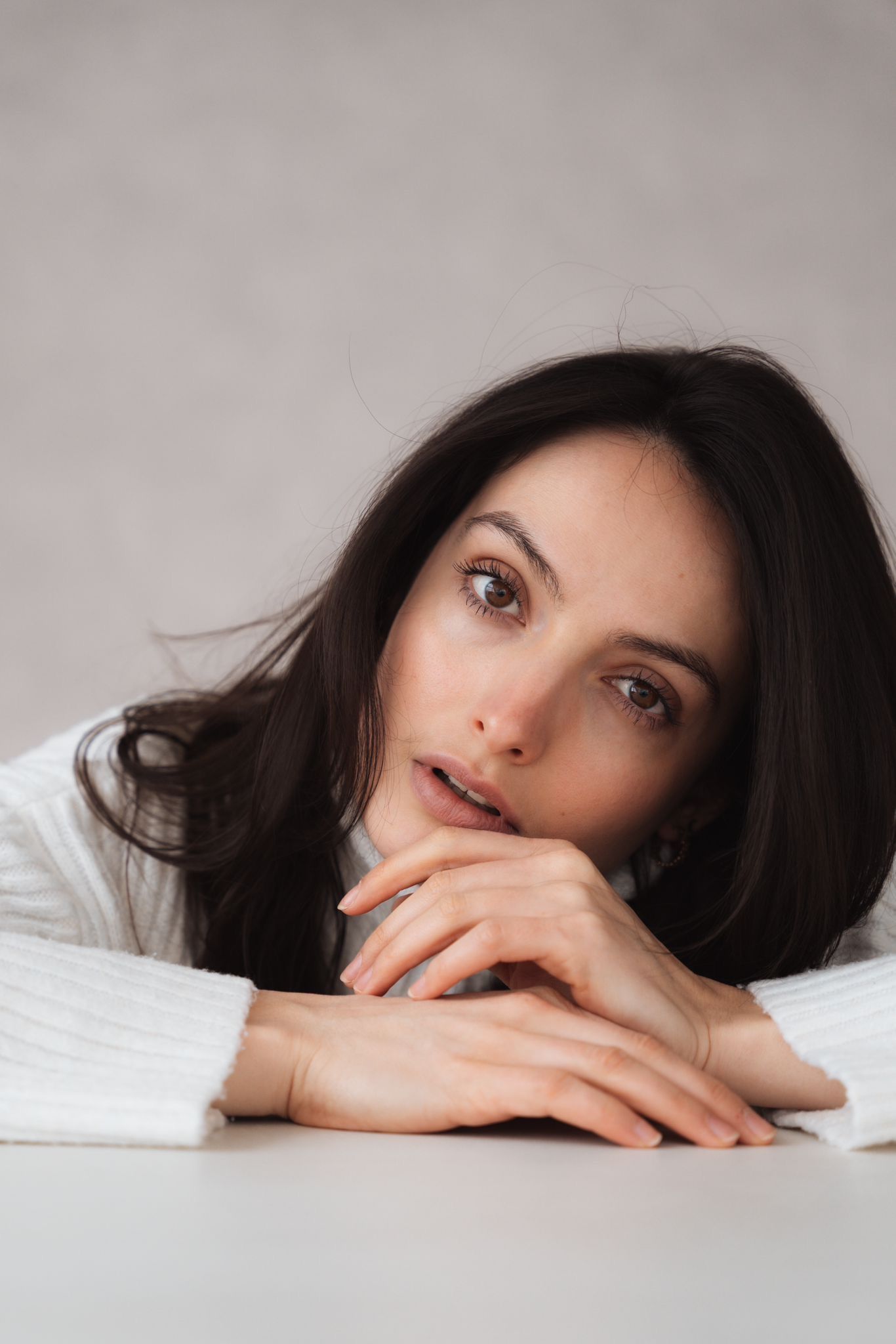 Close-up portrait series showing contemplative poses against light background.