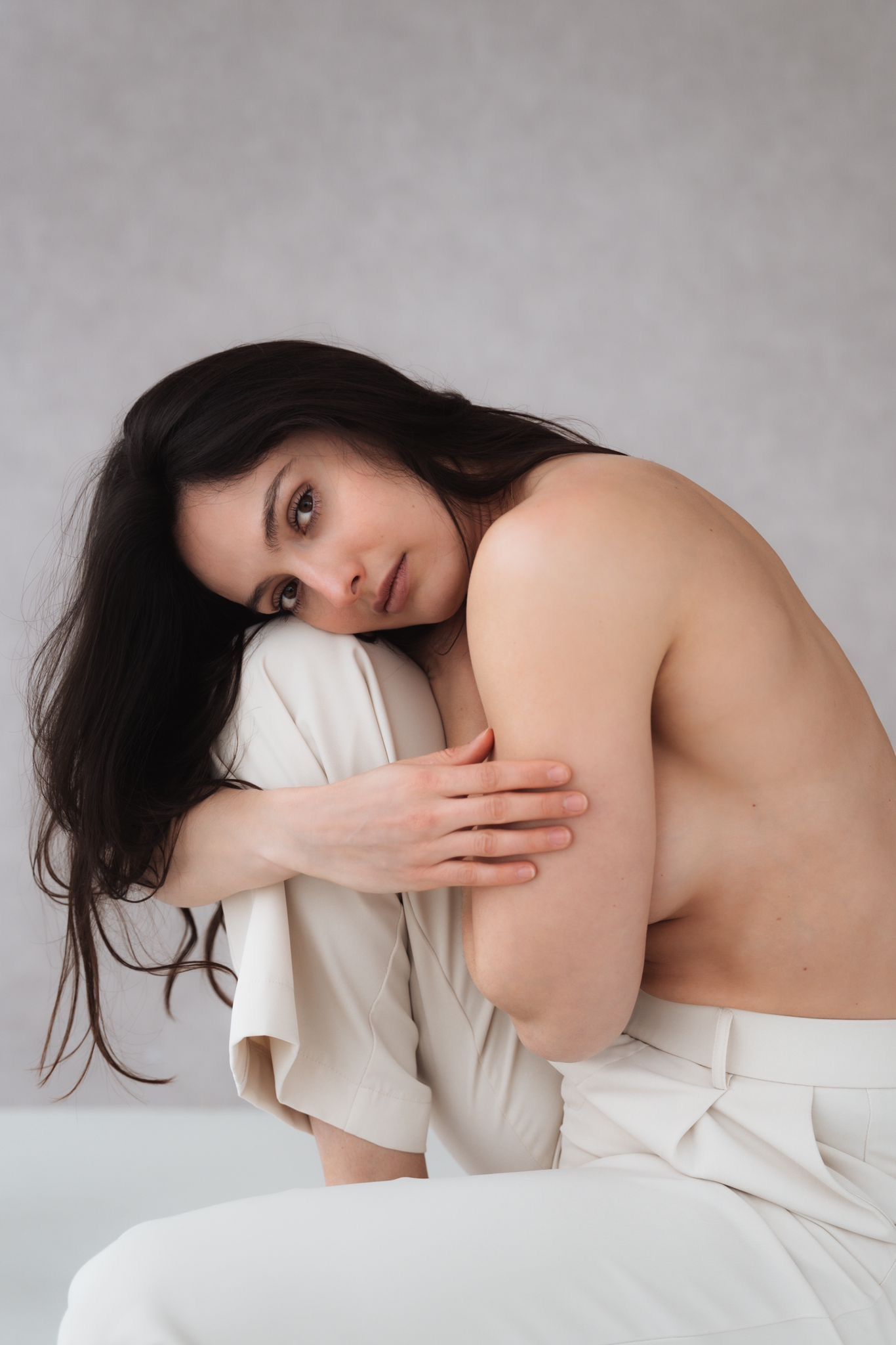 Artistic portrait series showing figure draped in cream-colored fabric.
