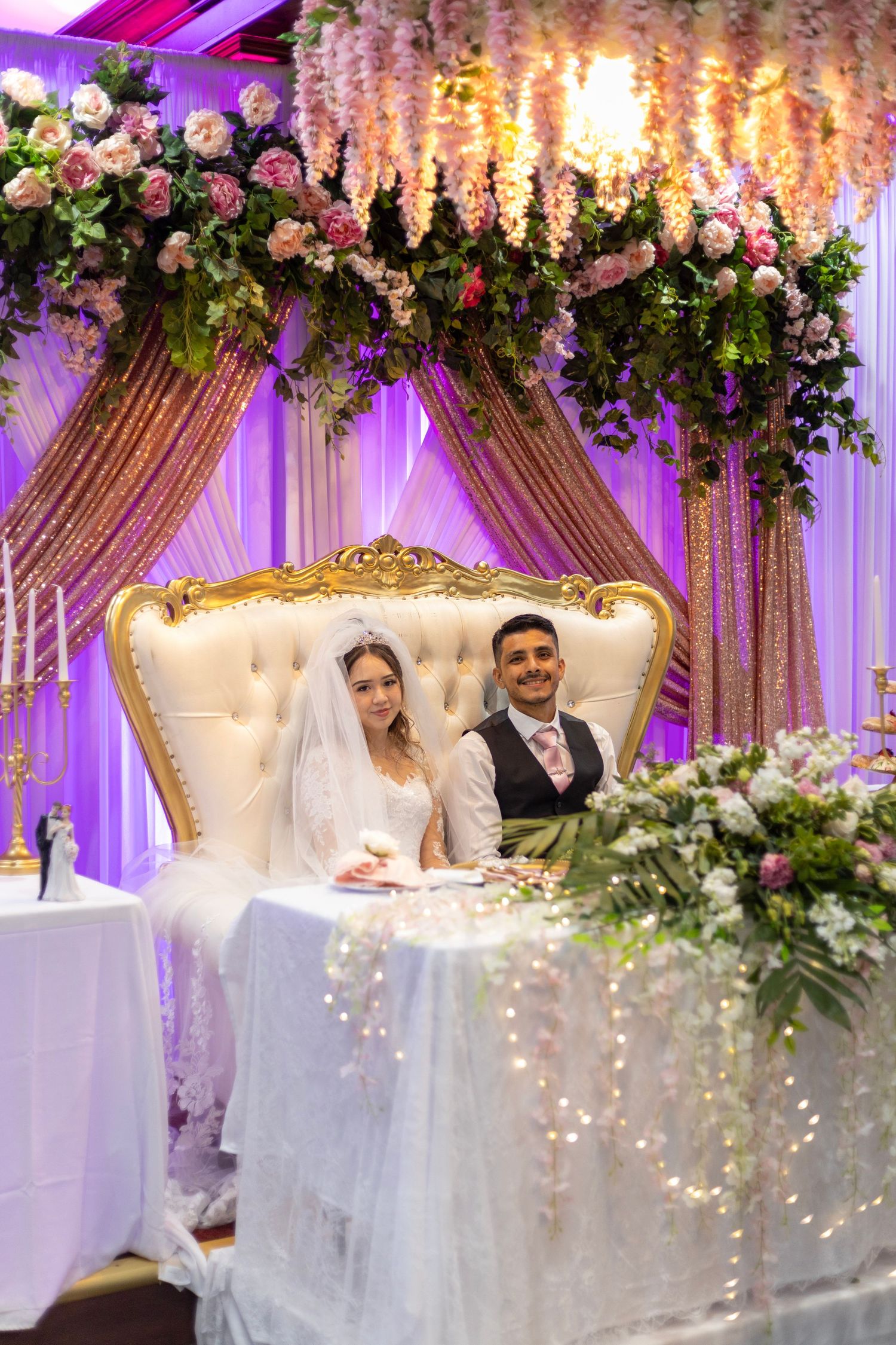 Decorated wedding stage with flowers and draped backdrop